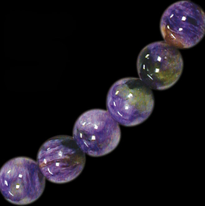 Charoite, perles rondes de 6 ou 8 mm. Vendu en bracelet de 17 à 21 cm ou en collier de 45. Qualité AA à AAA, superbes perles !