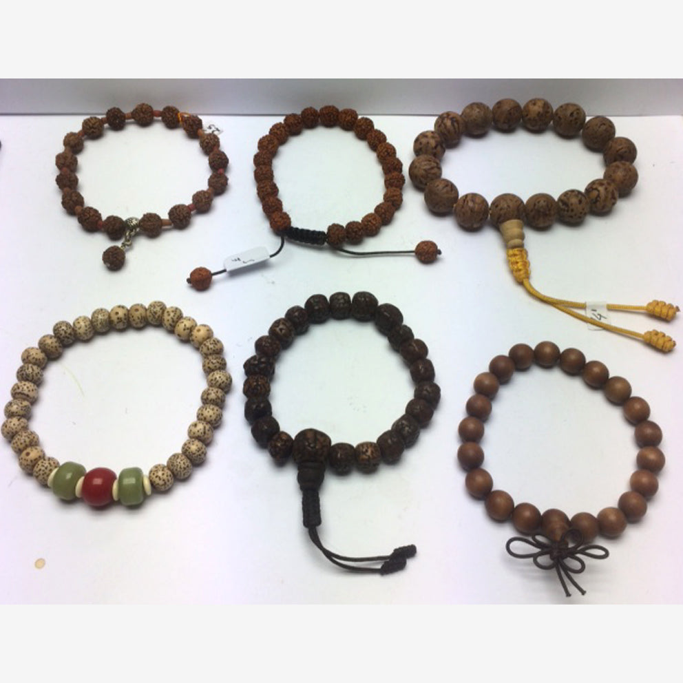 Collection of bracelets made from seeds or wood, with a sliding Mala-style closure. Beautiful quality, perfect!