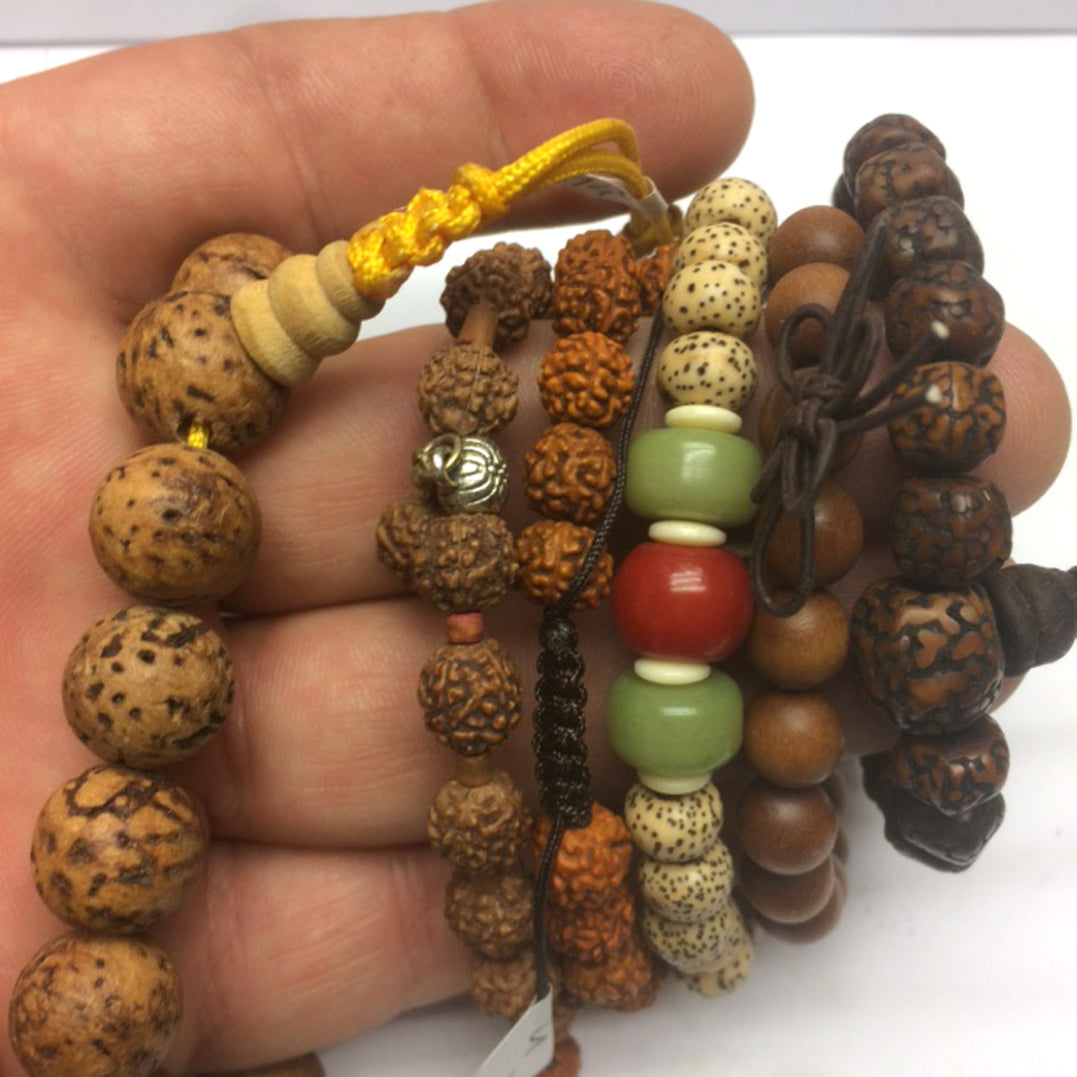 Collection of bracelets made from seeds or wood, with a sliding Mala-style closure. Beautiful quality, perfect!