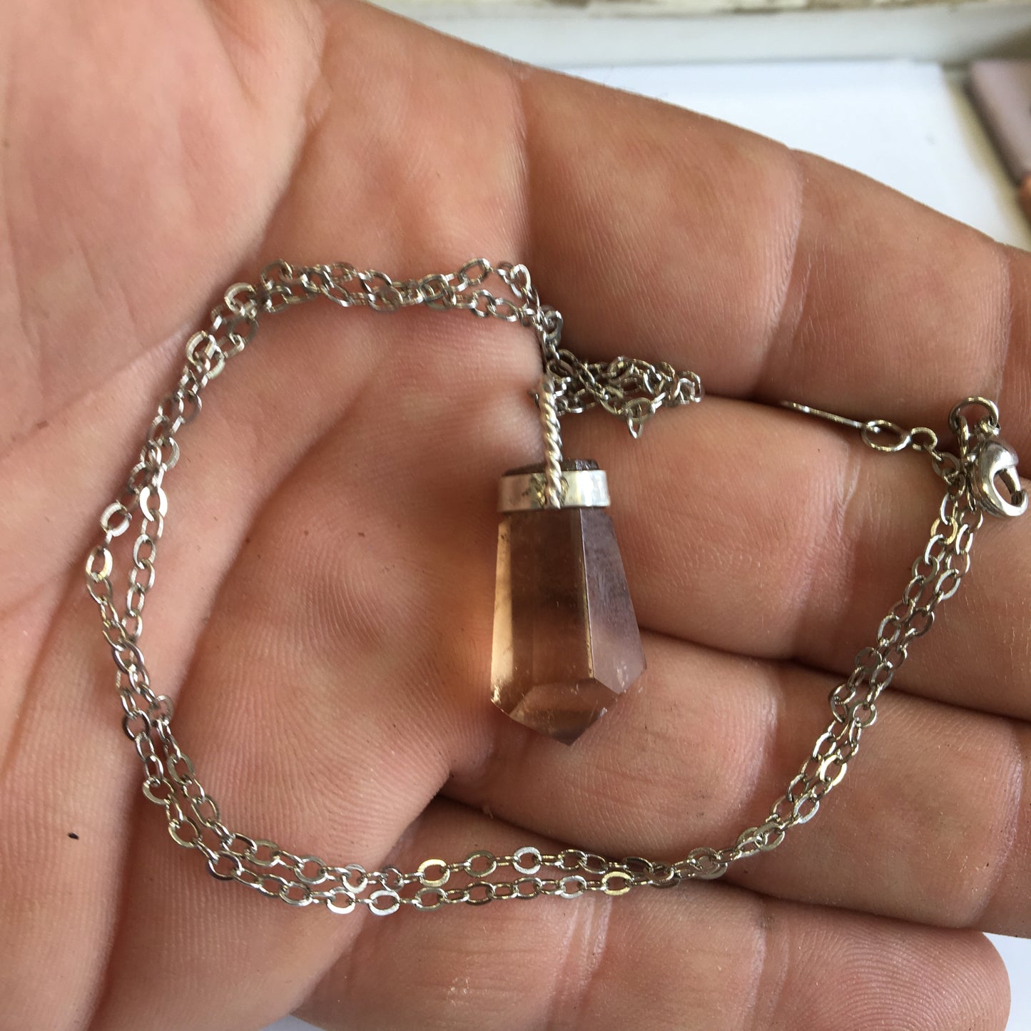 Aquamarine pendant set in silver with a metal design! Unique piece measuring 38 millimeters high x 12 millimeters wide x 8 millimeters thick. Sold with an adjustable black cord. Made in Pakistan!