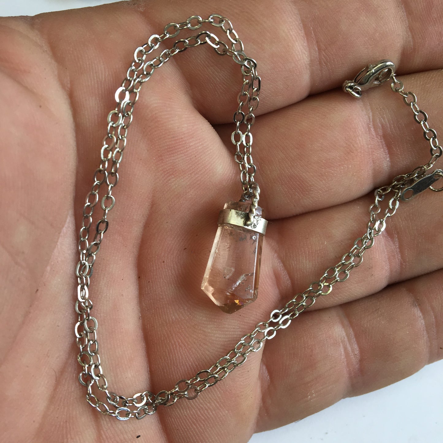 Aquamarine pendant set in silver with a metal design! Unique piece measuring 38 millimeters high x 12 millimeters wide x 8 millimeters thick. Sold with an adjustable black cord. Made in Pakistan!
