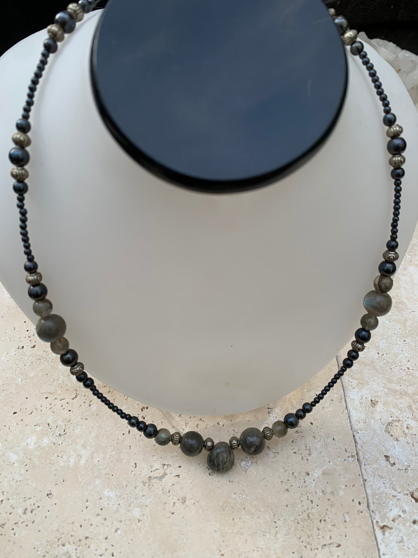 Labradorite avec hématite, 'collier/ chute de perle', de forme ronde de 2 à 10 millimètres de diamètre. 45 centimètres de longueur, fermoir à vis. Très belle pièce montée par Gem & Zen !