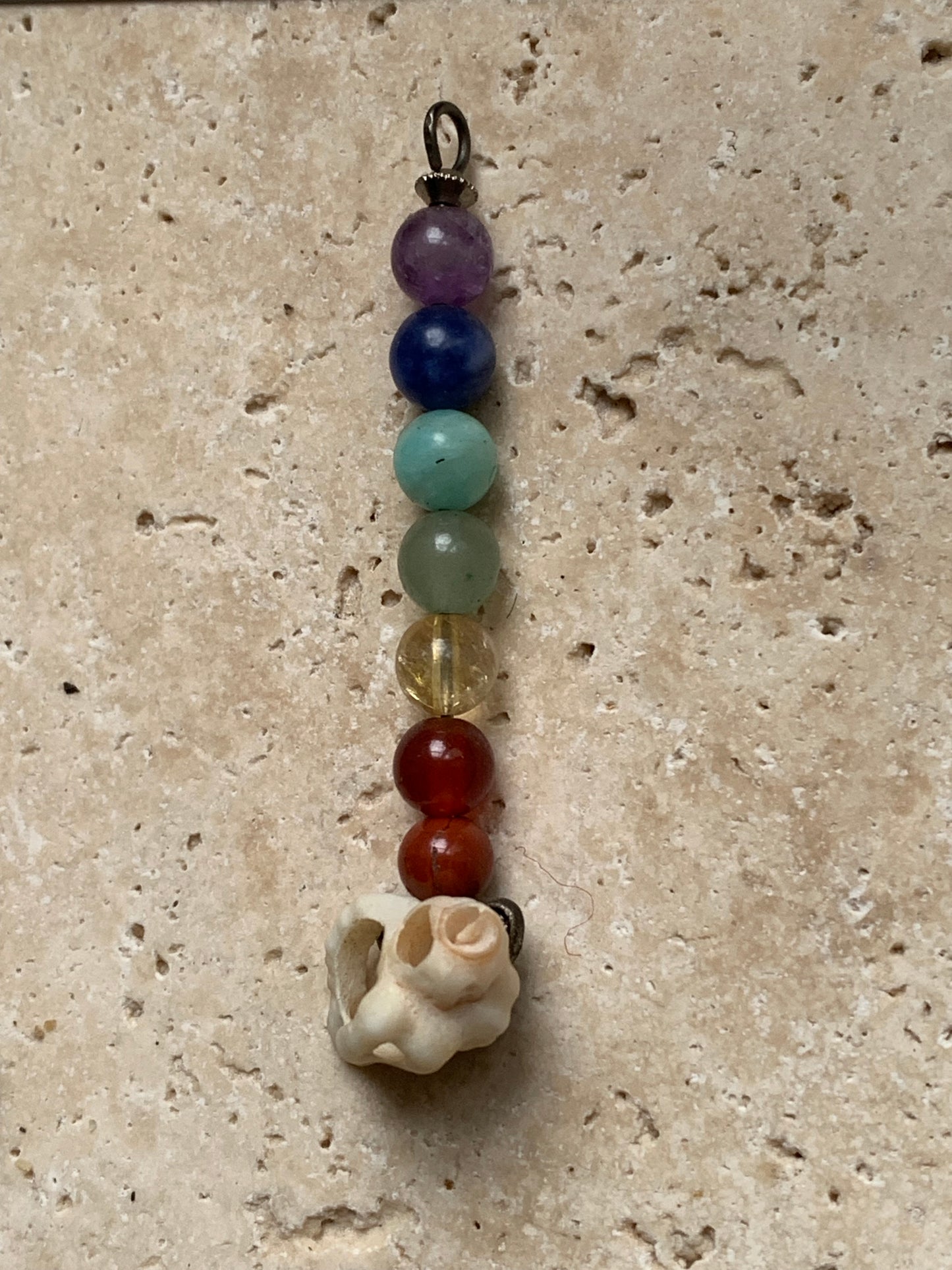 '7 chakras' pendant made by Gem & Zen, choice of 7 beads with or without a natural shell! 52 millimeters high x 6 millimeters in diameter. Sold with an adjustable black cord!