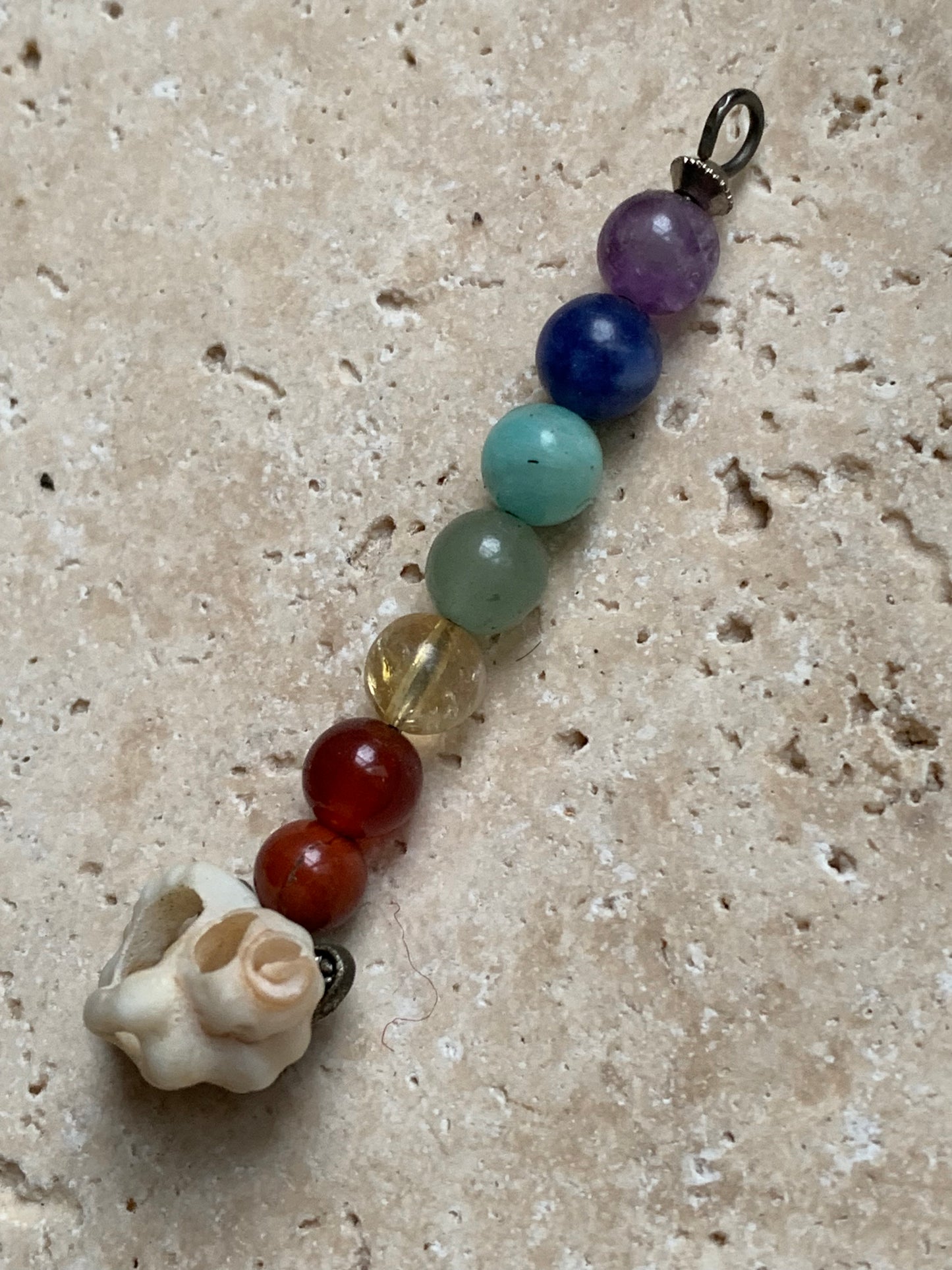 '7 chakras' pendant made by Gem & Zen, choice of 7 beads with or without a natural shell! 52 millimeters high x 6 millimeters in diameter. Sold with an adjustable black cord!
