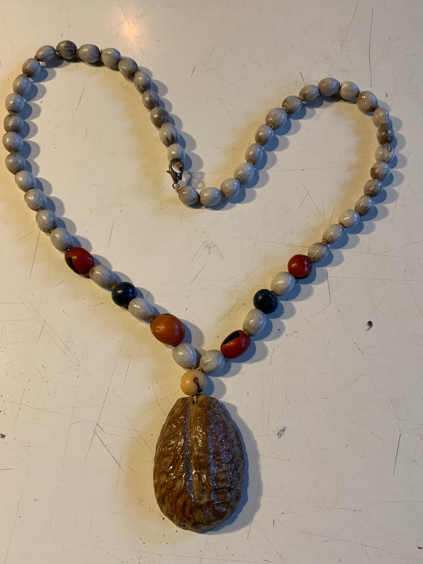 Collier du Pérou en graines naturelles, perles de ± 8 à 10 millimètres. Taille de 55 centimètres de longueur environ + pendentif (coque). Superbe pièce !