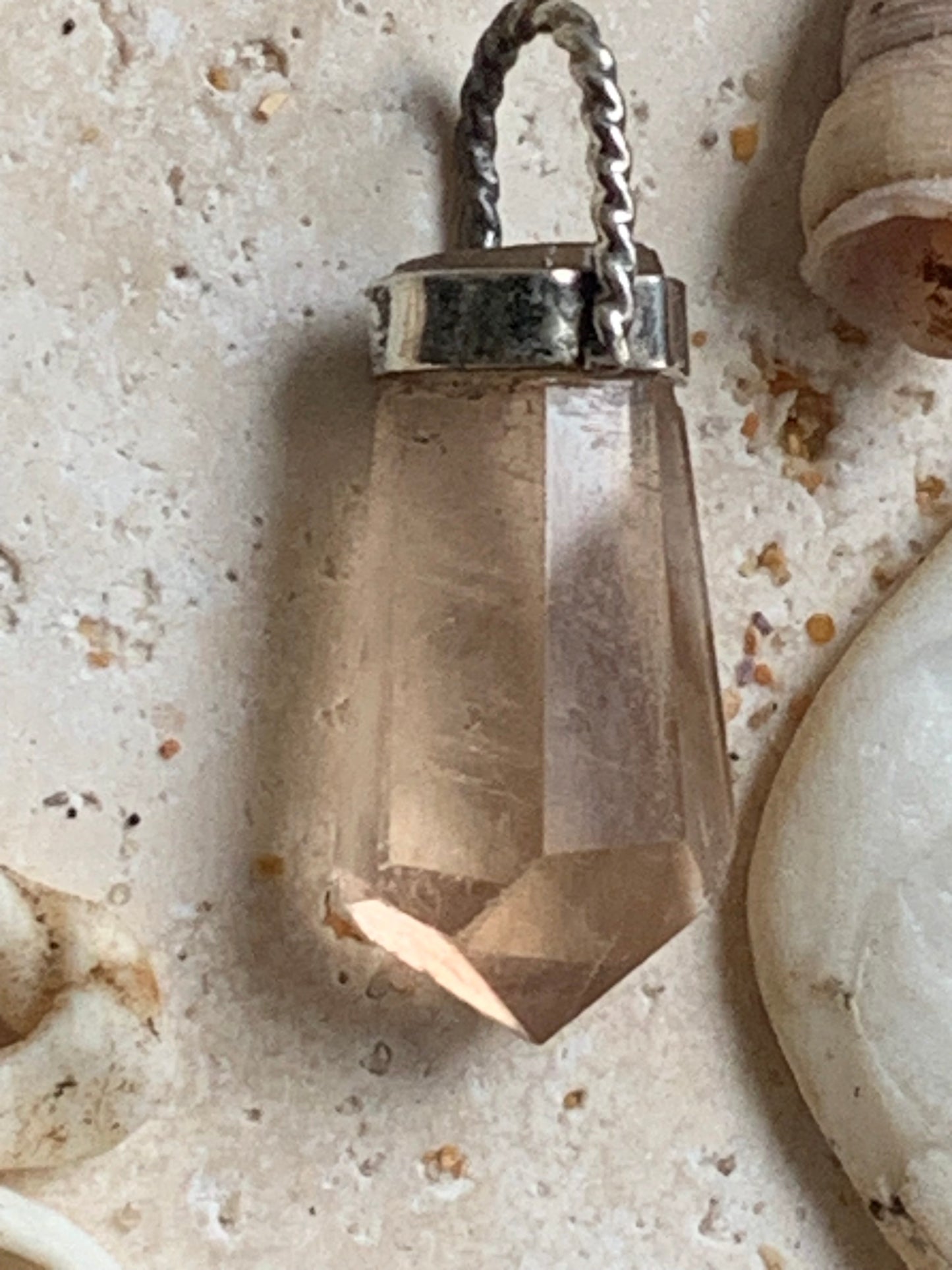 Aquamarine pendant set in silver with a metal design! Unique piece measuring 38 millimeters high x 12 millimeters wide x 8 millimeters thick. Sold with an adjustable black cord. Made in Pakistan!