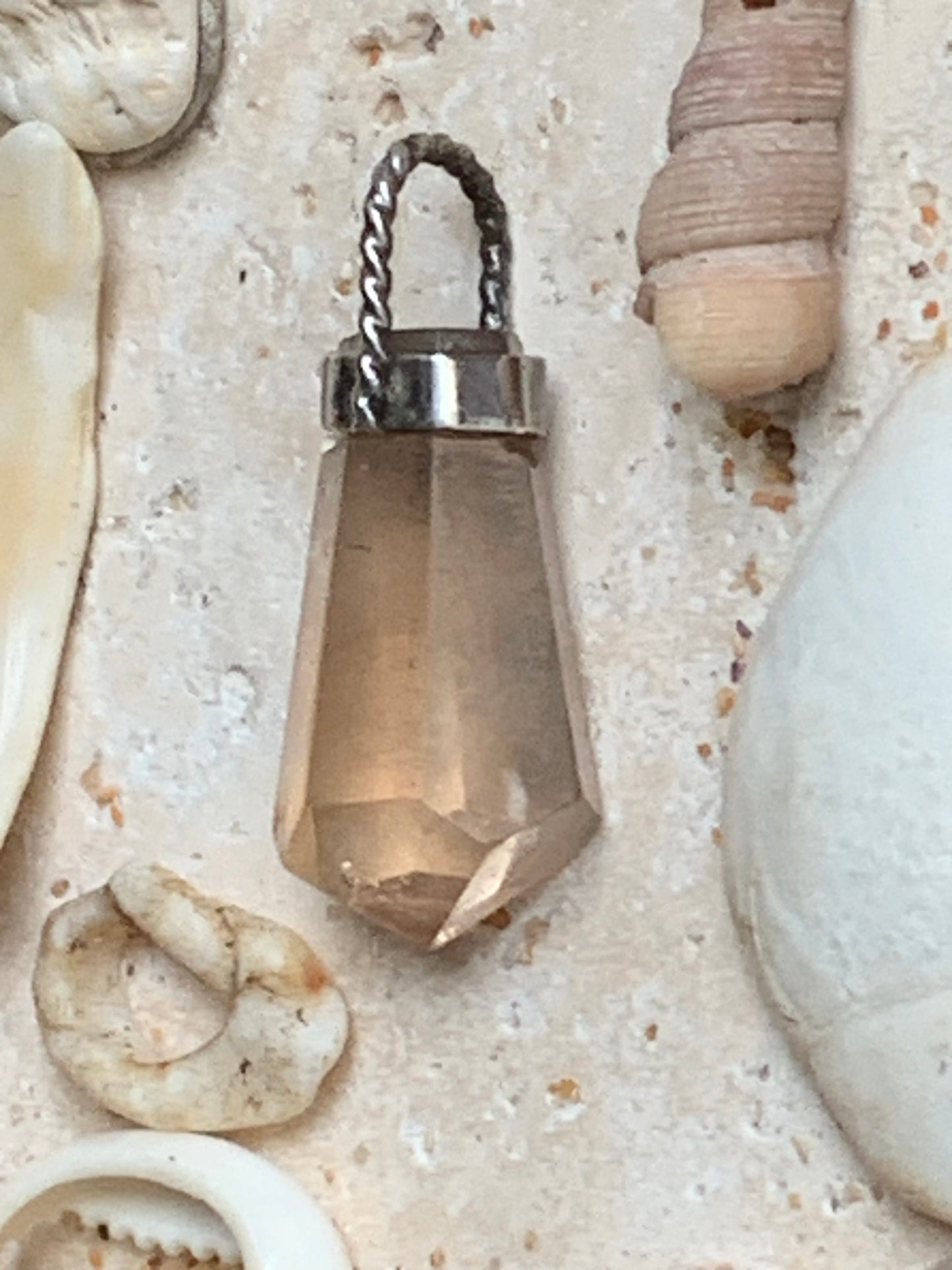 Aquamarine pendant set in silver with a metal design! Unique piece measuring 38 millimeters high x 12 millimeters wide x 8 millimeters thick. Sold with an adjustable black cord. Made in Pakistan!