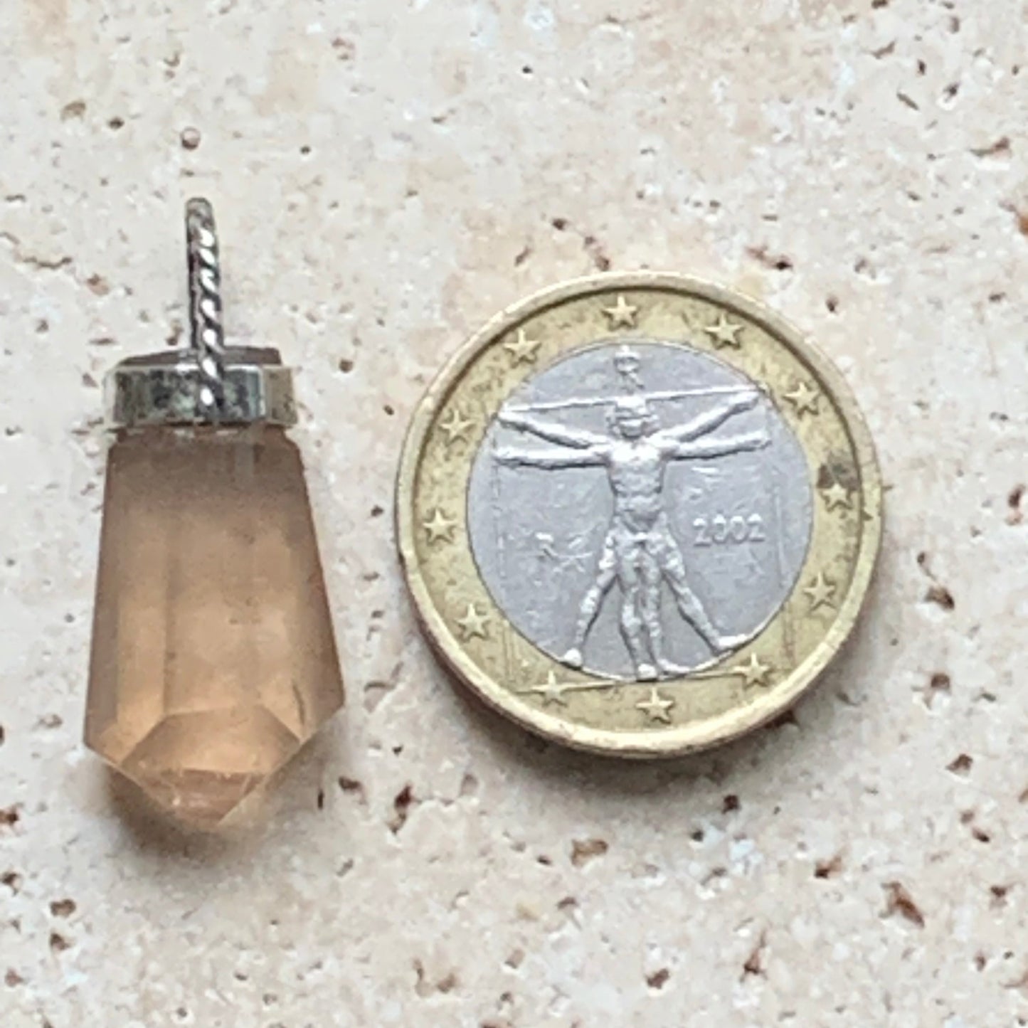 Aquamarine pendant set in silver with a metal design! Unique piece measuring 38 millimeters high x 12 millimeters wide x 8 millimeters thick. Sold with an adjustable black cord. Made in Pakistan!