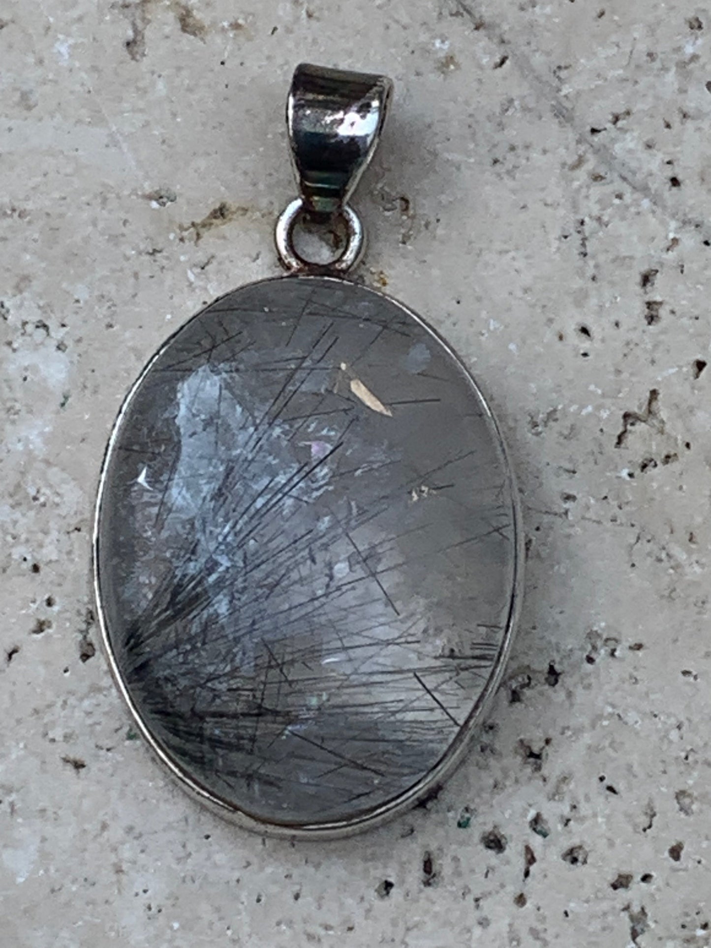 Rock crystal/quartz with black tourmaline inclusions! Silver pendant, 43 mm high x 25 mm wide x 10 mm thick. Sold with an adjustable black cord!