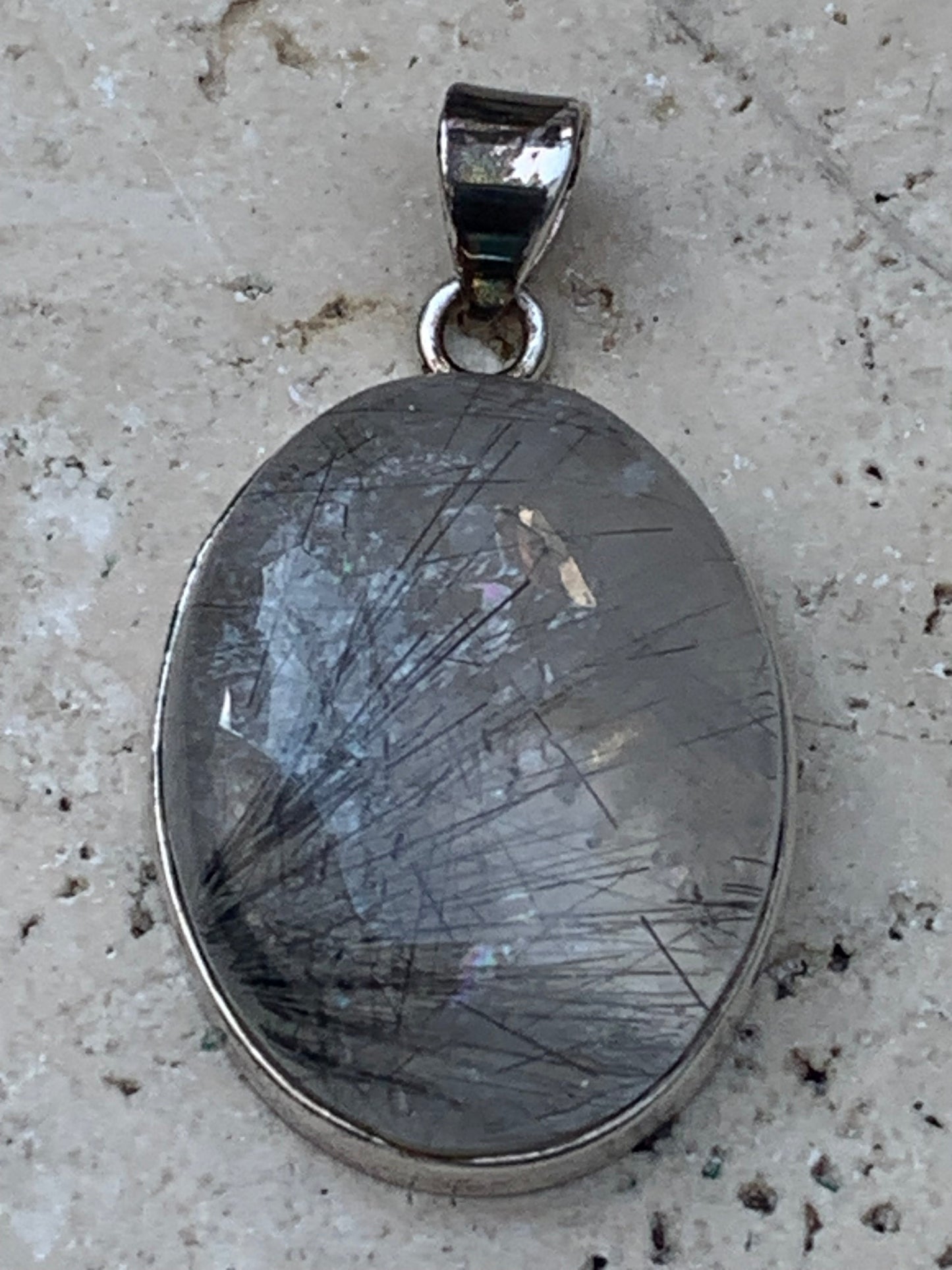 Rock crystal/quartz with black tourmaline inclusions! Silver pendant, 43 mm high x 25 mm wide x 10 mm thick. Sold with an adjustable black cord!