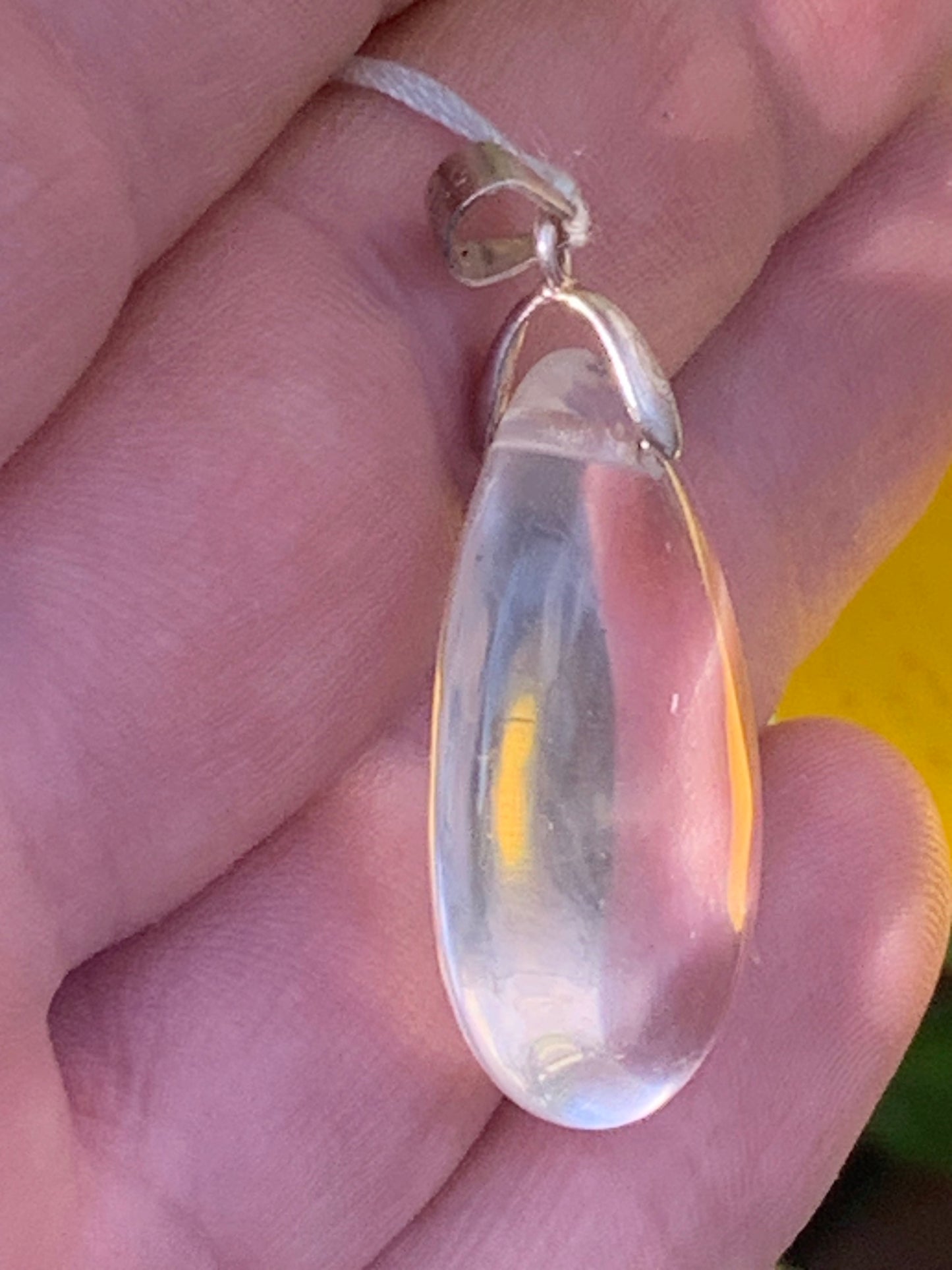 Rock crystal/quartz, AAA quality silver 'drop' pendant, 40mm high x 20mm wide x 9mm thick. Sold with an adjustable black cord! A crystal jewel, for those who love to walk between light and mystery!