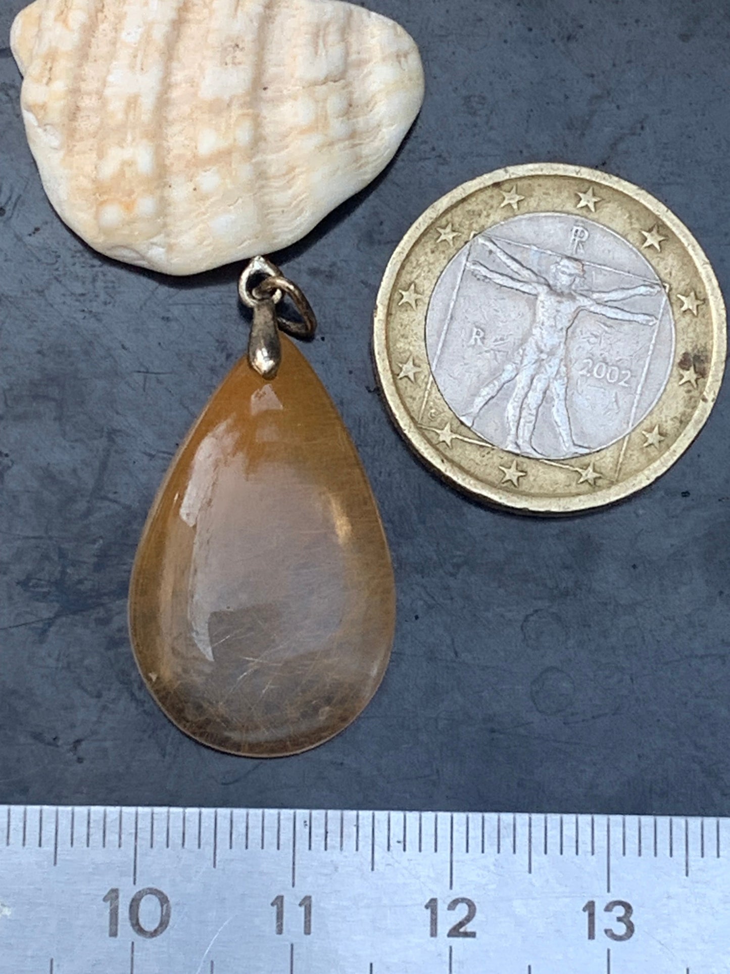 Rock crystal/quartz with golden rutile inclusions! Silver pendant, 33 mm high x 18 mm wide x 5 mm thick. Sold with an adjustable black cord!