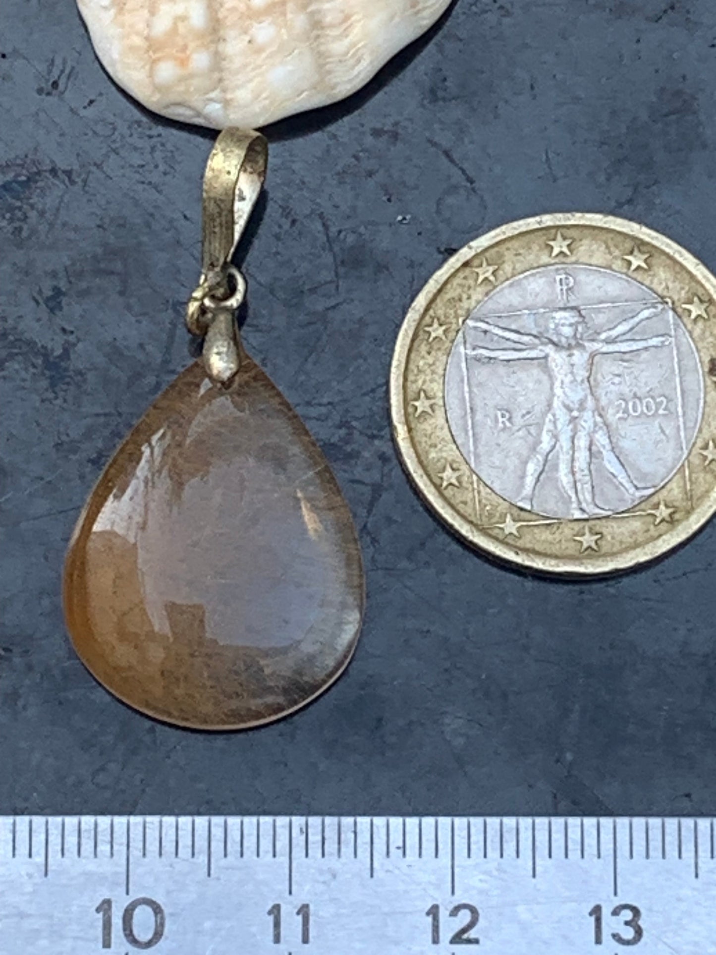 Rock crystal/quartz with golden rutile inclusions! Silver pendant, 40 mm high x 20 mm wide x 5 mm thick. Sold with an adjustable black cord!