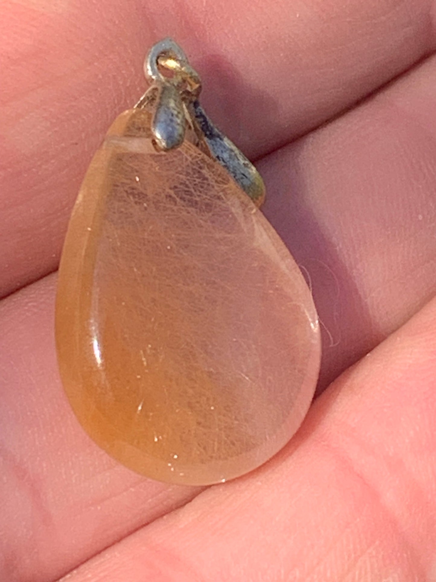Rock crystal/quartz with golden rutile inclusions! Silver pendant, 33 mm high x 18 mm wide x 5 mm thick. Sold with an adjustable black cord!