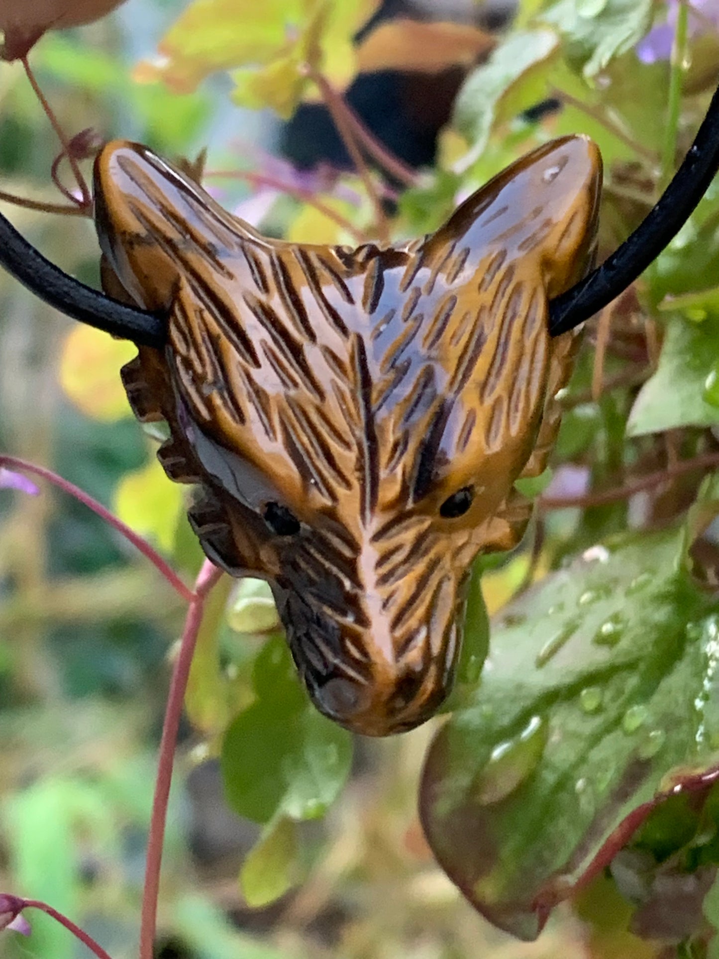 Tiger's Eye, 'Wolf Head' pendant, 38mm high x 30 wide x 15 thick, made in France. Sold with a free adjustable black cord!
