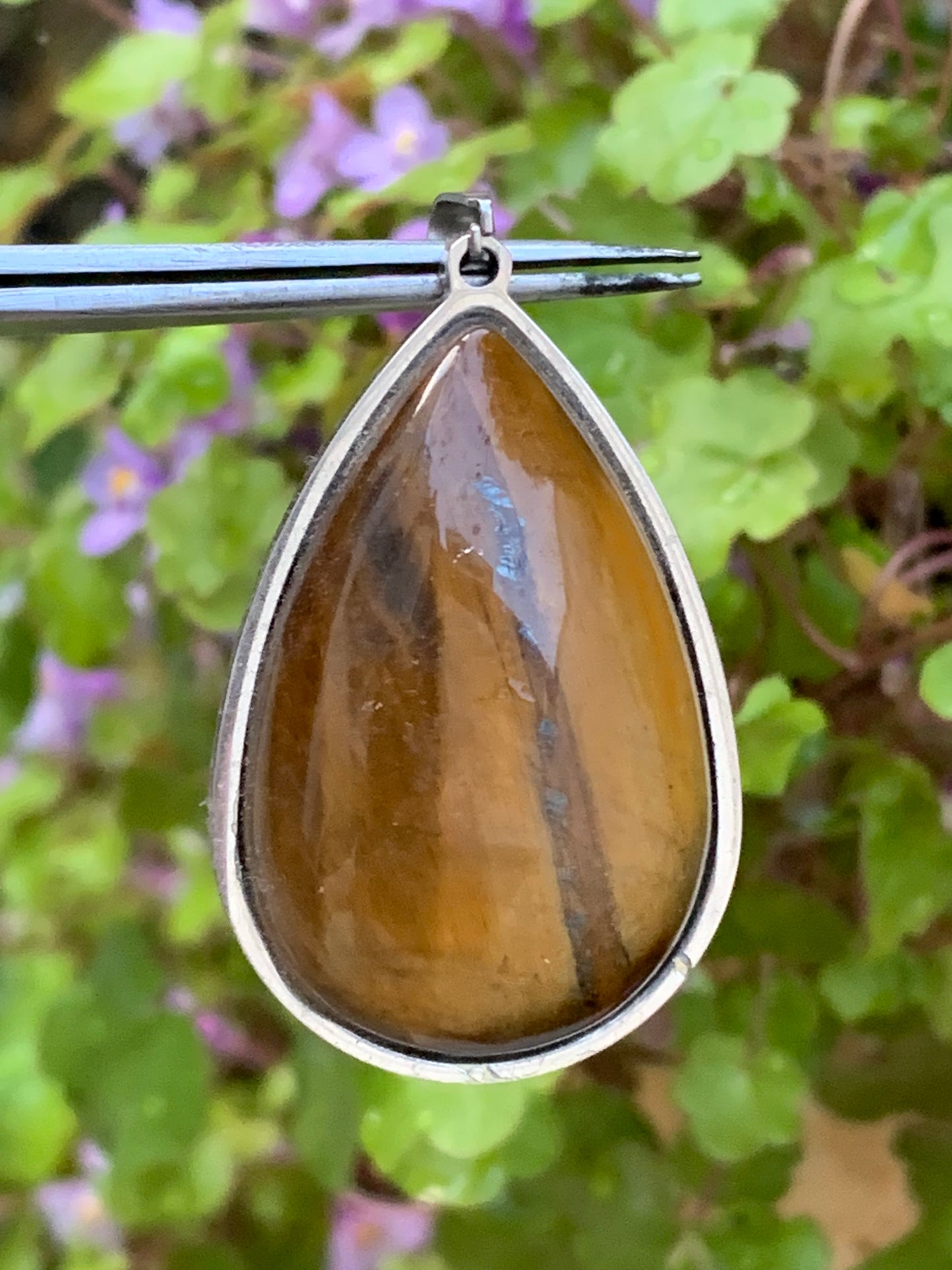 Tiger's Eye, pendant measuring 45mm high x 25mm wide x 8mm thick. Sold with a free adjustable black cord!