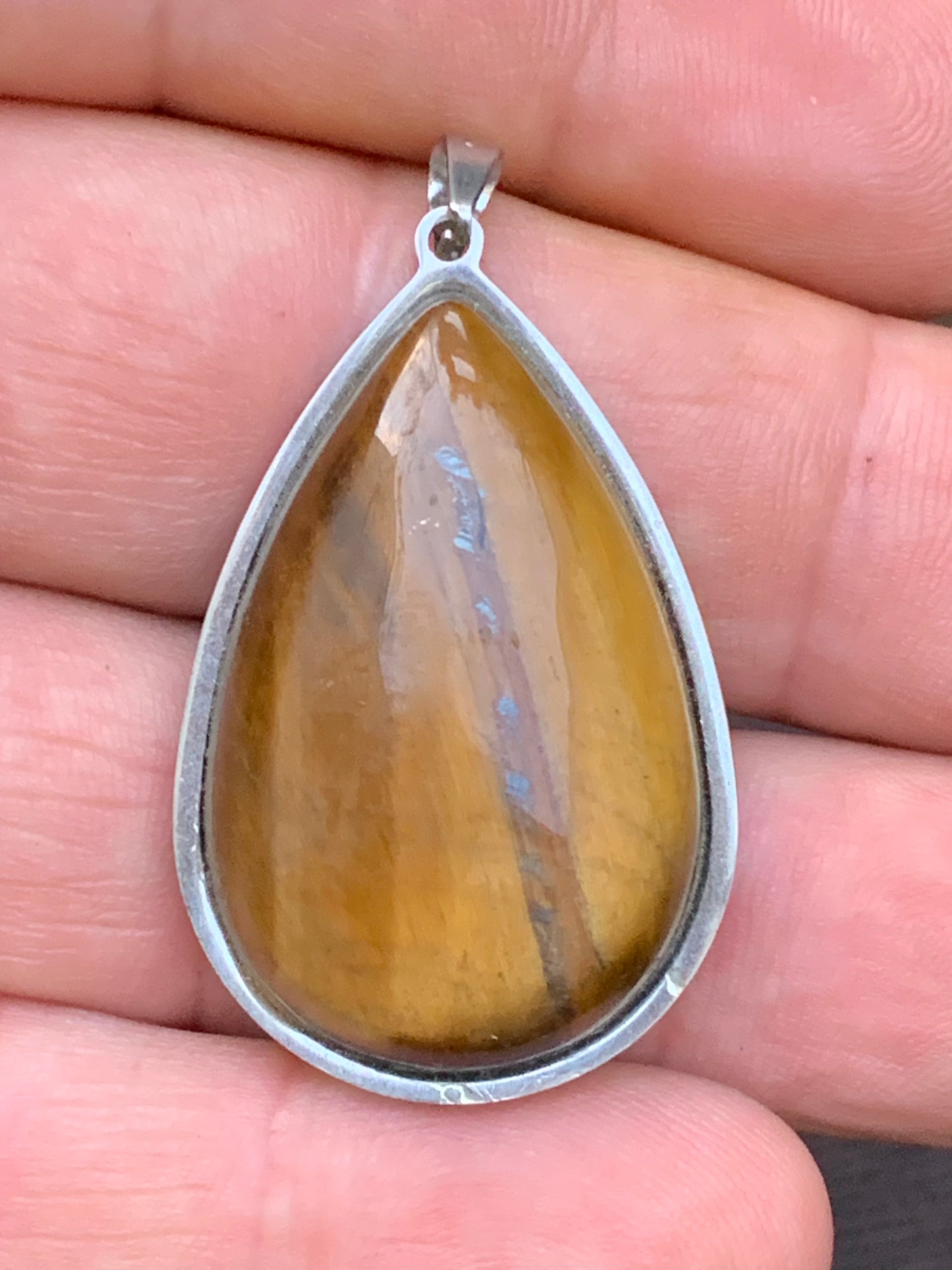 Tiger's Eye, pendant measuring 45mm high x 25mm wide x 8mm thick. Sold with a free adjustable black cord!