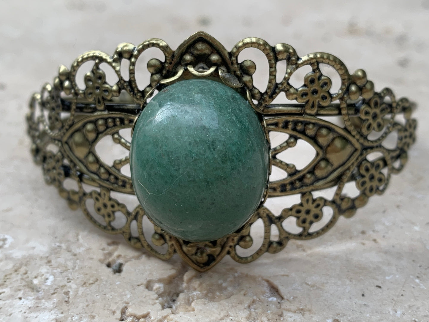 Superbe bracelet de style ancien avec cabochon d'Aventurine verte de 6,5 x 6 centimètres. Fait en Laiton couleur 'bronze', magnifique pièce fait par Gem & Zen !