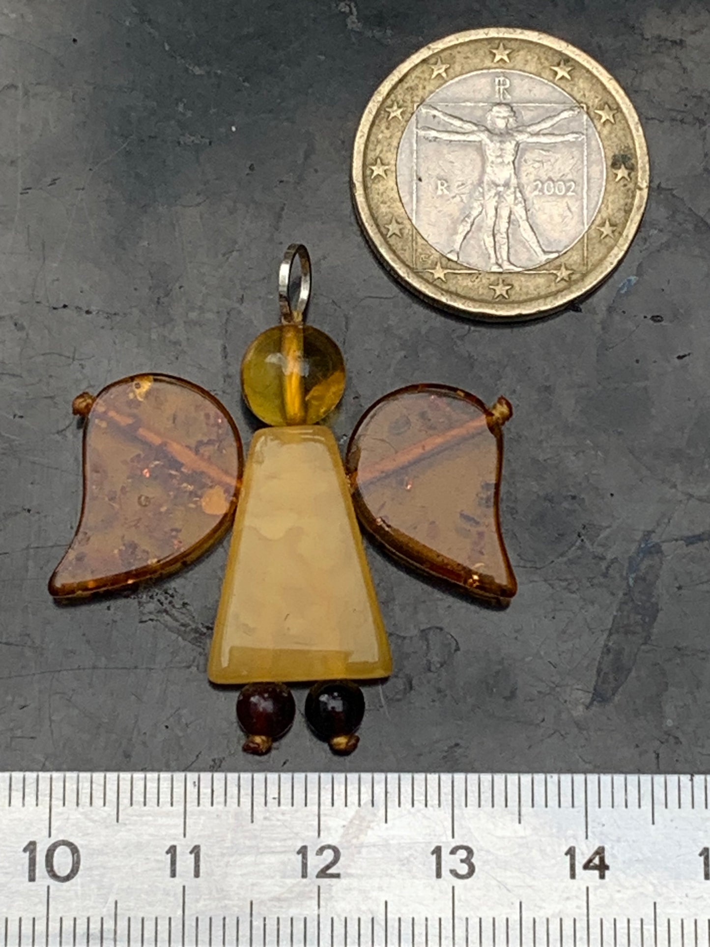 Amber, angel-shaped pendant measuring 38x35x8 millimeters, sold with a sliding (adjustable) black leather cord measuring 40 to 70 centimeters!