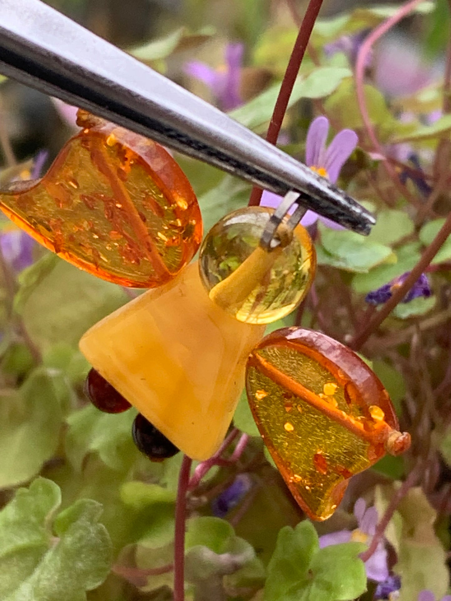 Amber, angel-shaped pendant measuring 38x35x8 millimeters, sold with a sliding (adjustable) black leather cord measuring 40 to 70 centimeters!