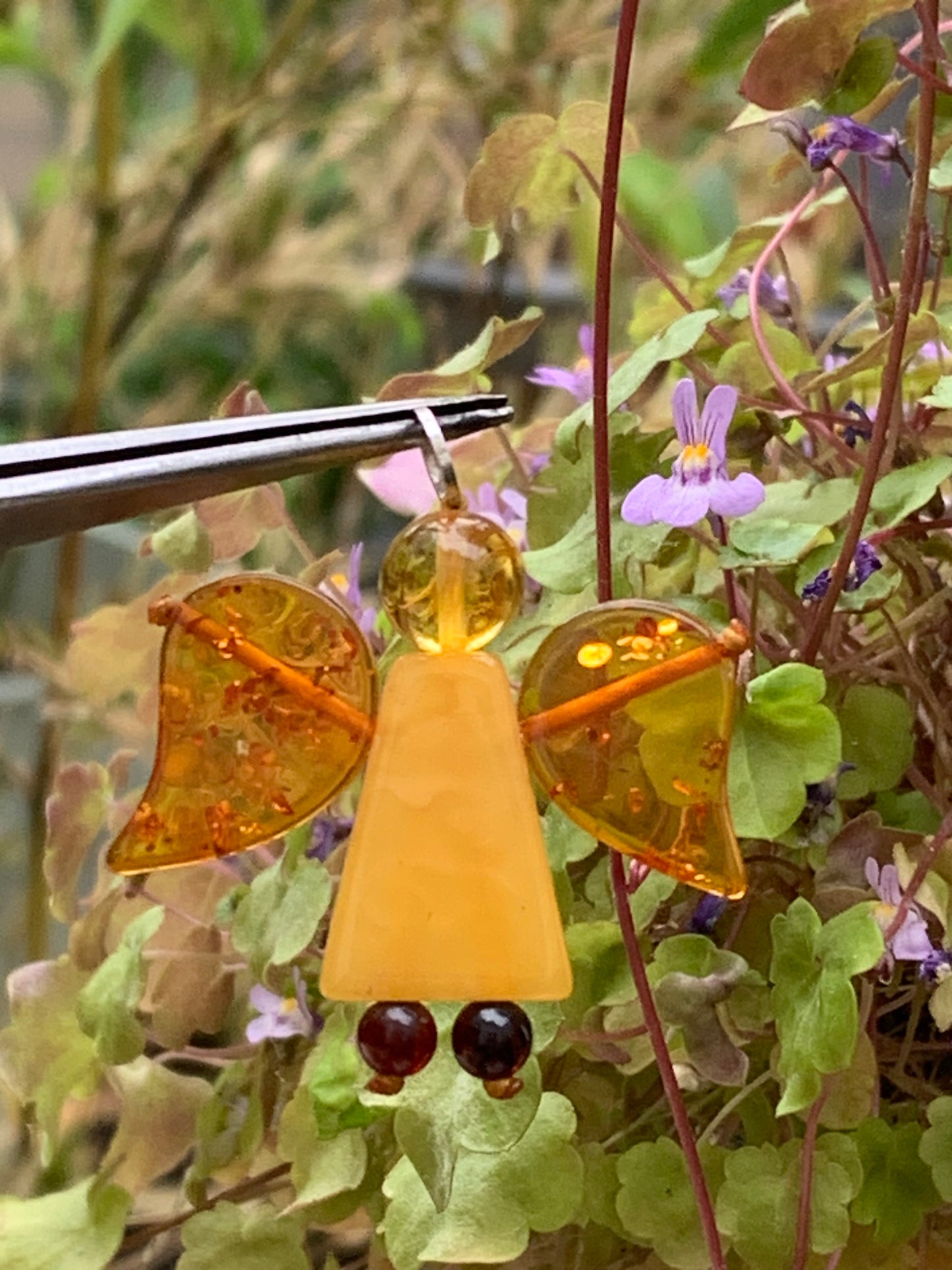 Amber, angel-shaped pendant measuring 38x35x8 millimeters, sold with a sliding (adjustable) black leather cord measuring 40 to 70 centimeters!