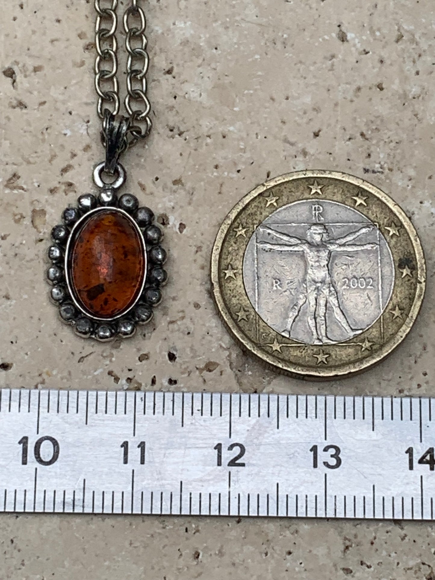 Amber, pendant measuring 25x13x5 millimeters, sold with a 42 centimeter black leather cord!