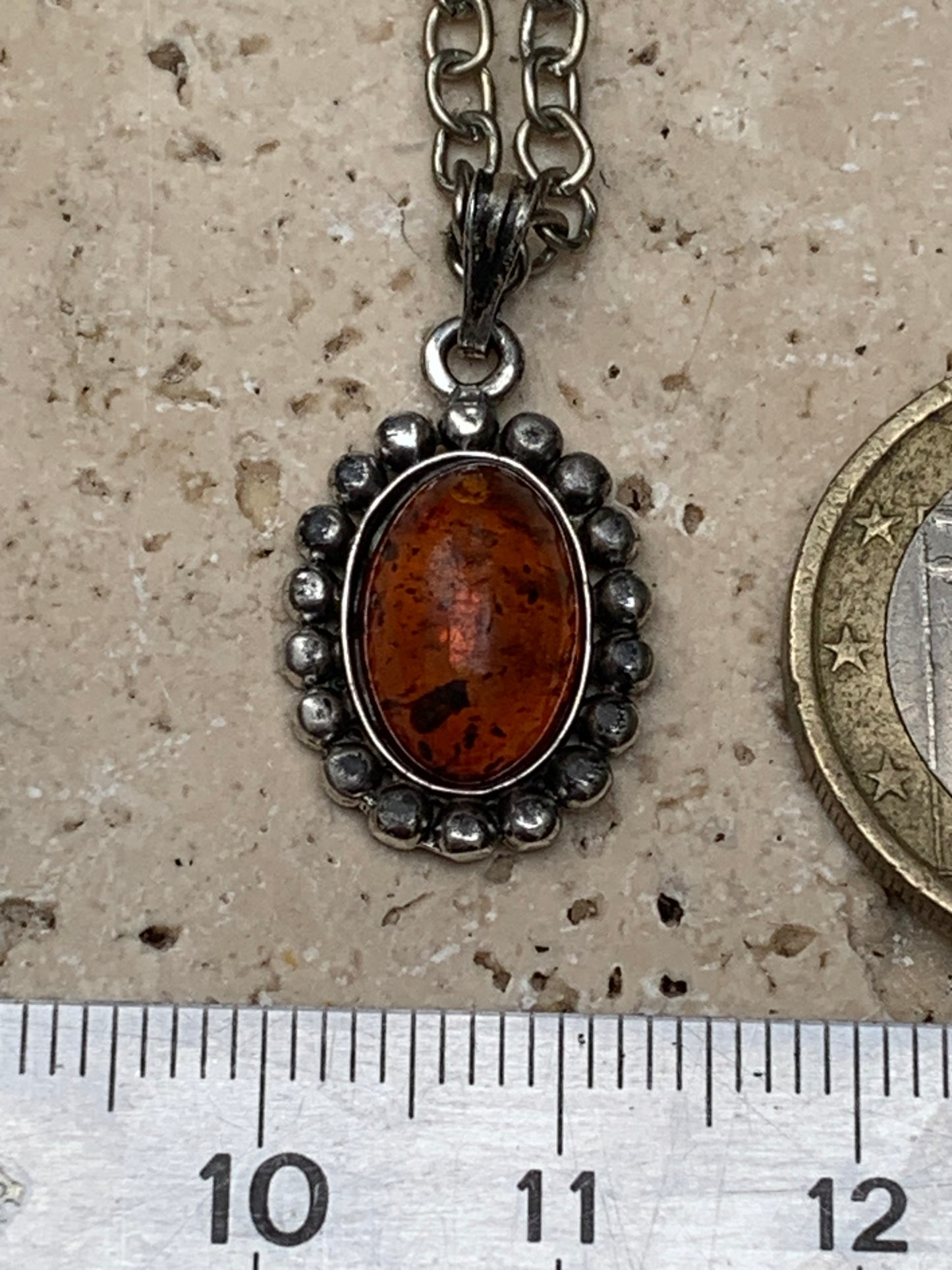 Amber, pendant measuring 25x13x5 millimeters, sold with a 42 centimeter black leather cord!