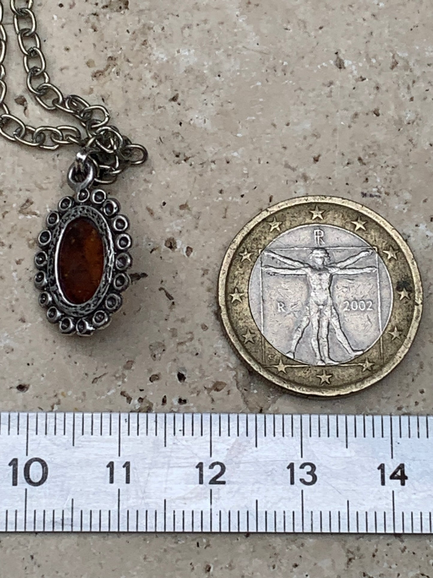 Amber, pendant measuring 25x13x5 millimeters, sold with a 42 centimeter black leather cord!