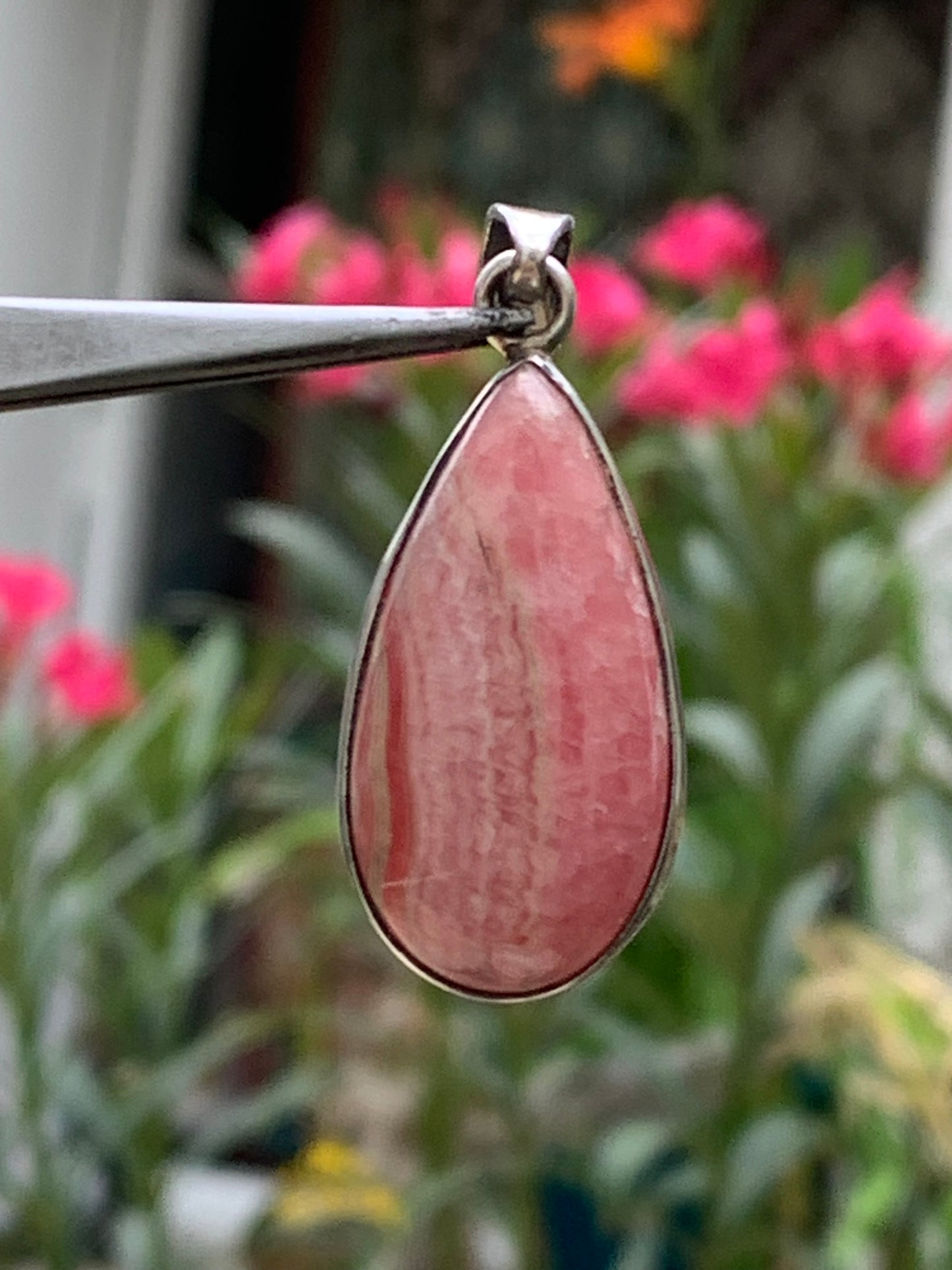 Rhodochrosite! 44mm x17mm x7mm Silver Pendant made by Gem & Zen. Sold with an adjustable black cord!