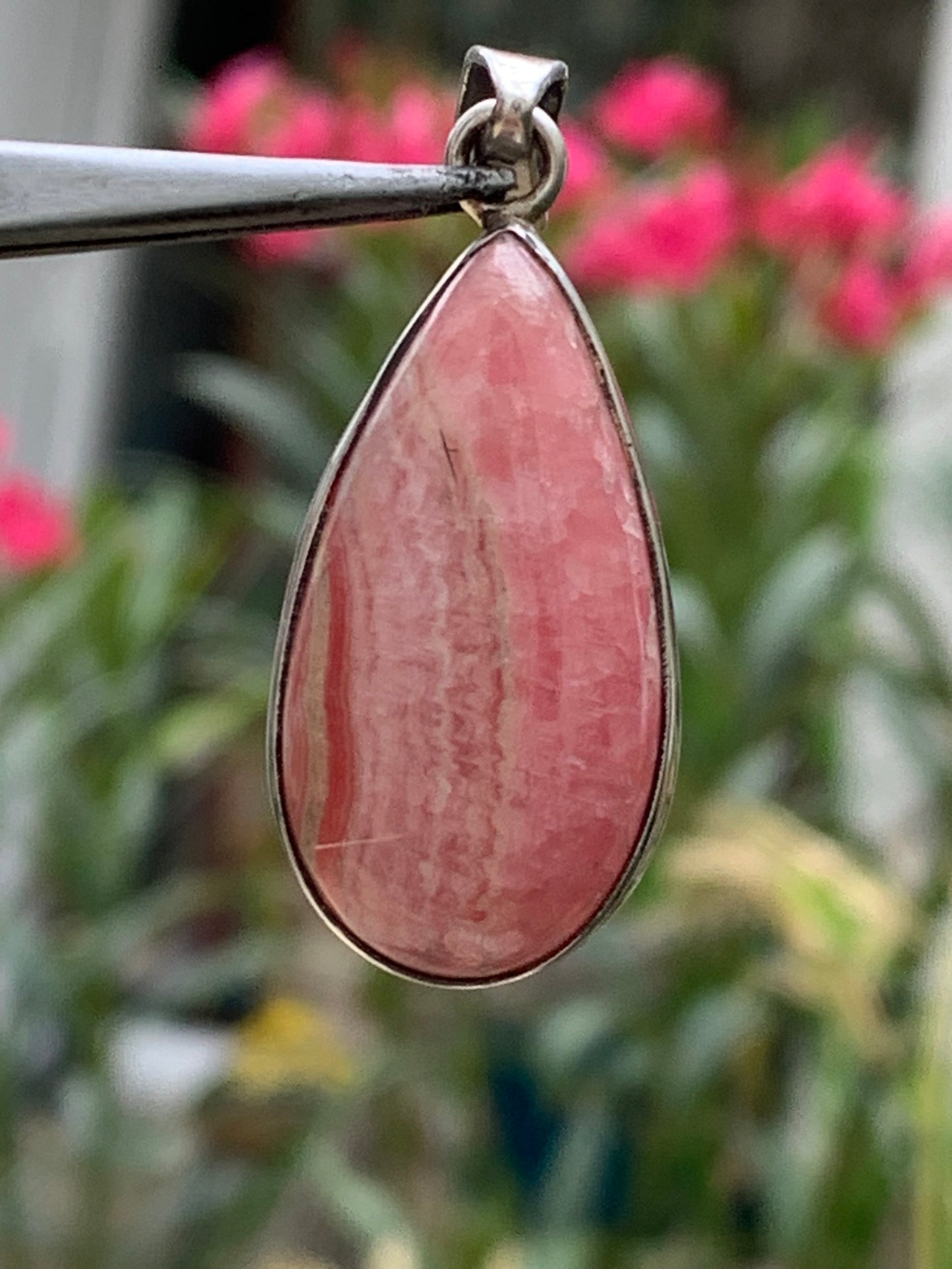 Rhodochrosite! 44mm x17mm x7mm Silver Pendant made by Gem & Zen. Sold with an adjustable black cord!