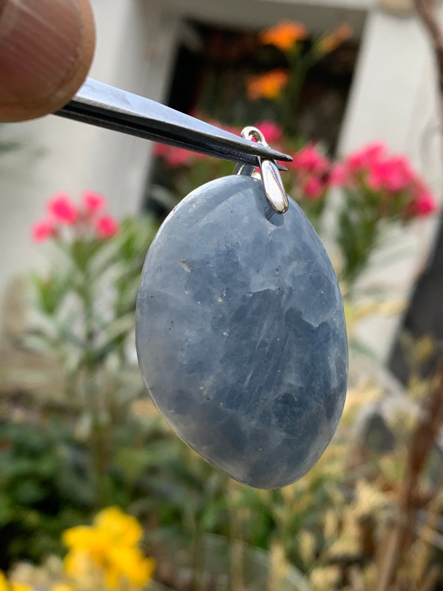 Blue calcite, pendant measuring 47mm high x 37mm wide x 18mm deep. Sold with an adjustable black cord!