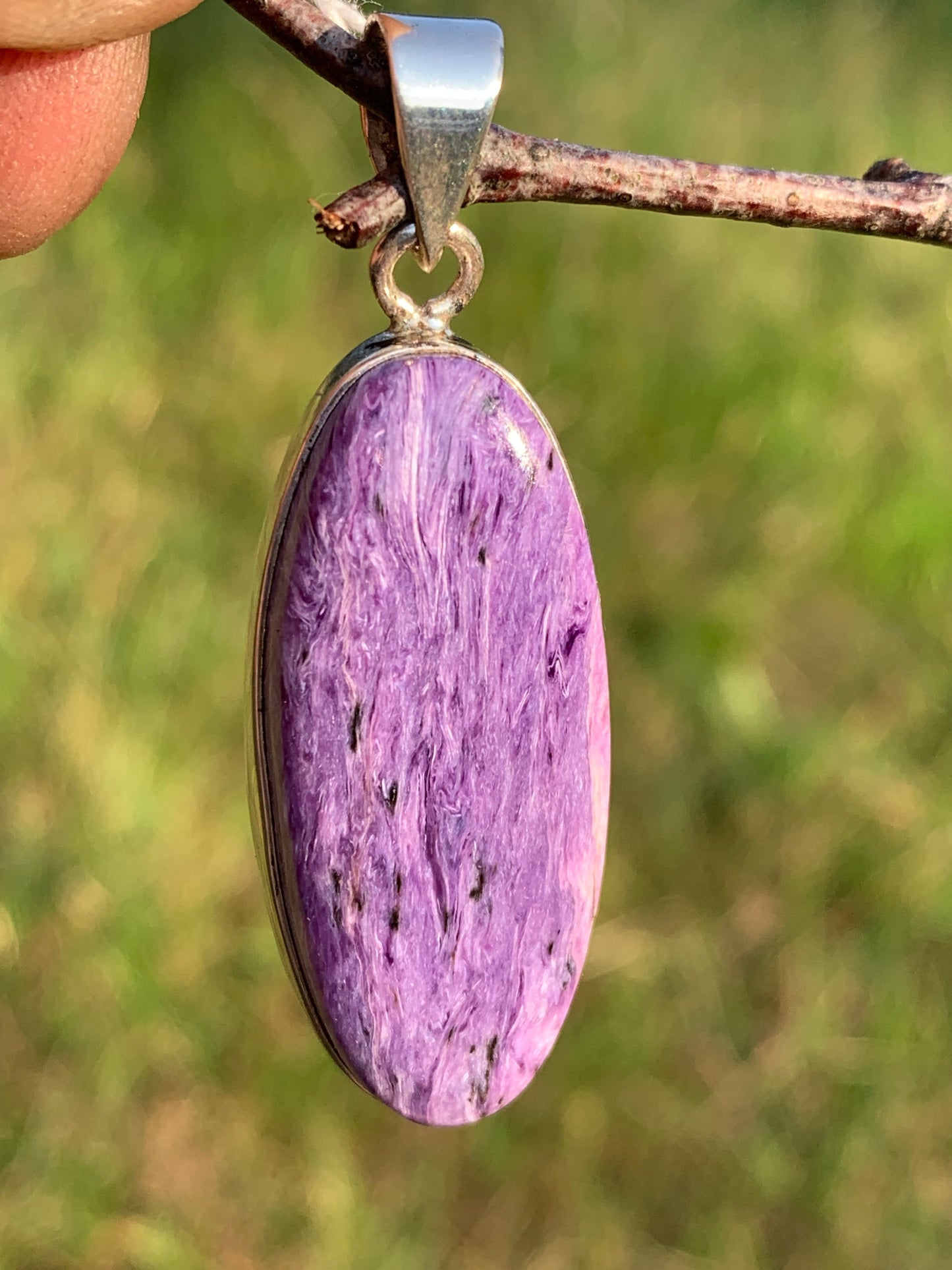 Charoite, pendant set in solid silver measuring 50mm x 17 x 8. Sold with adjustable black cord, ready to wear!
