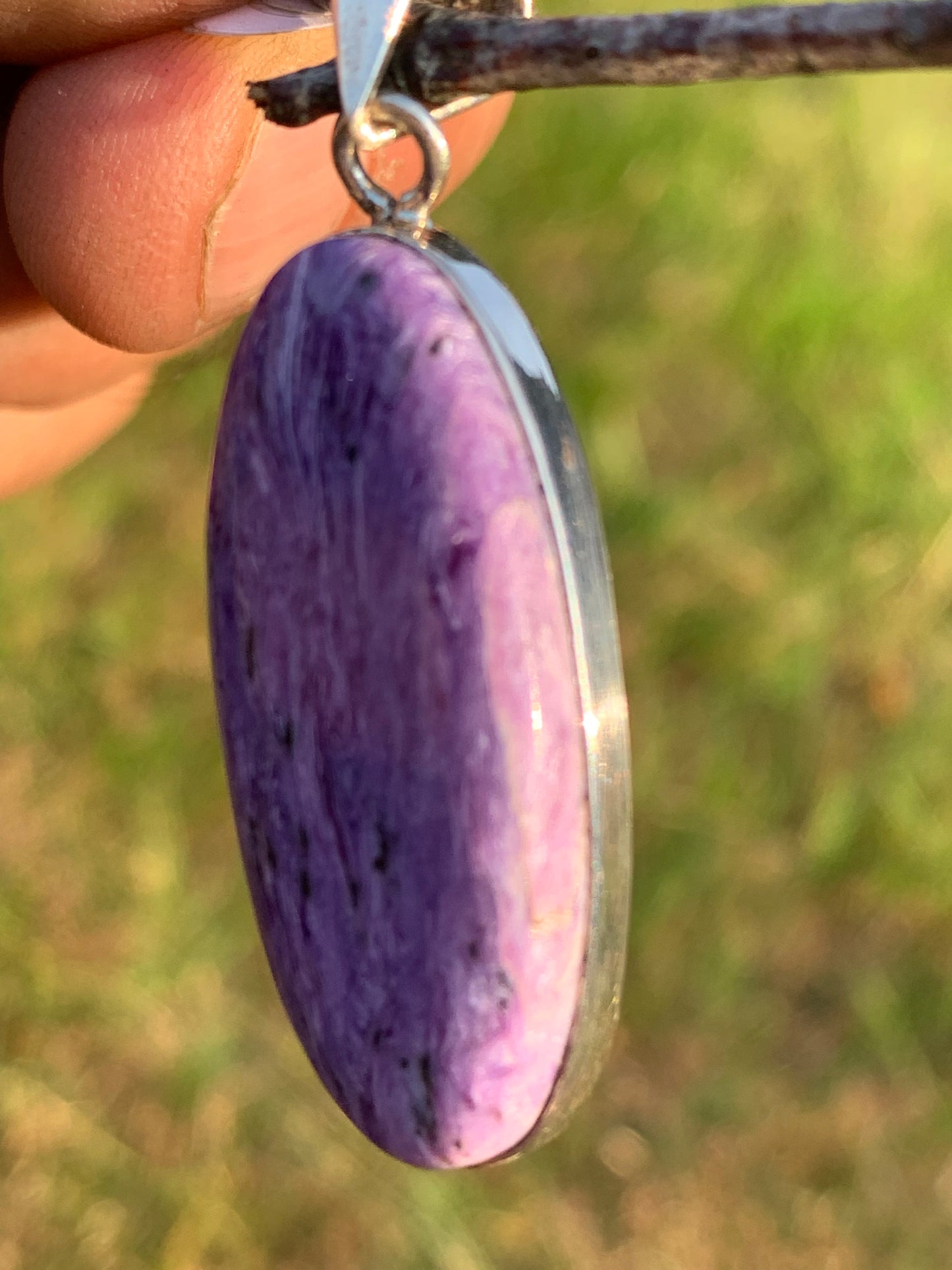Charoite, pendant set in solid silver measuring 50mm x 17 x 8. Sold with adjustable black cord, ready to wear!