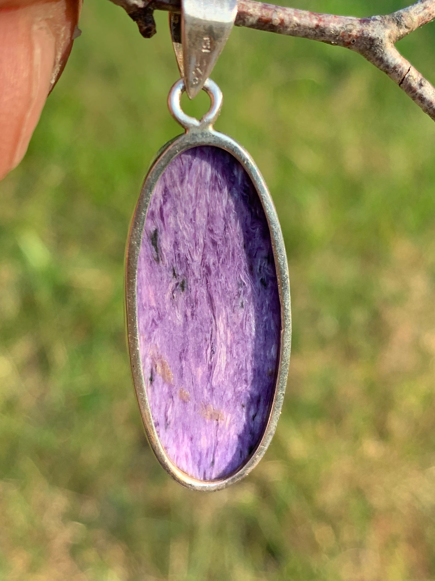 Charoite, pendant set in solid silver measuring 50mm x 17 x 8. Sold with adjustable black cord, ready to wear!