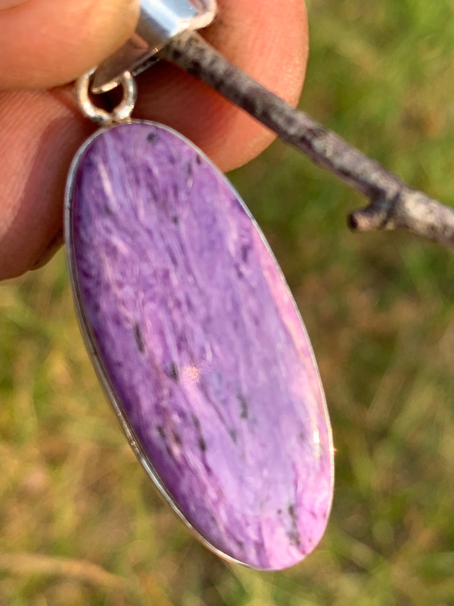 Charoite, pendant set in solid silver measuring 50mm x 17 x 8. Sold with adjustable black cord, ready to wear!