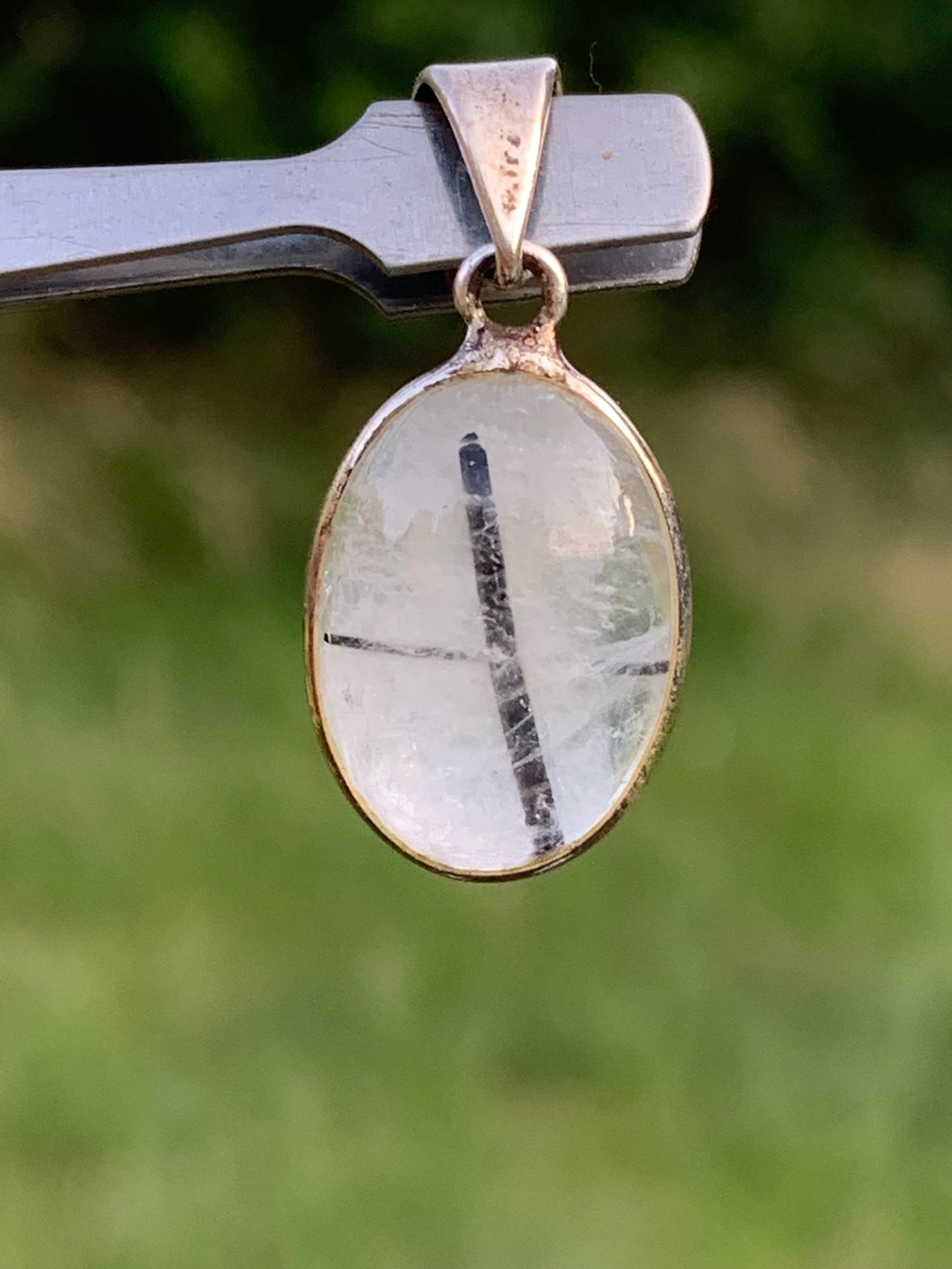 Rock crystal/quartz with black tourmaline inclusions! Silver pendant, 28mm high x13 x7. Sold with an adjustable black cord!