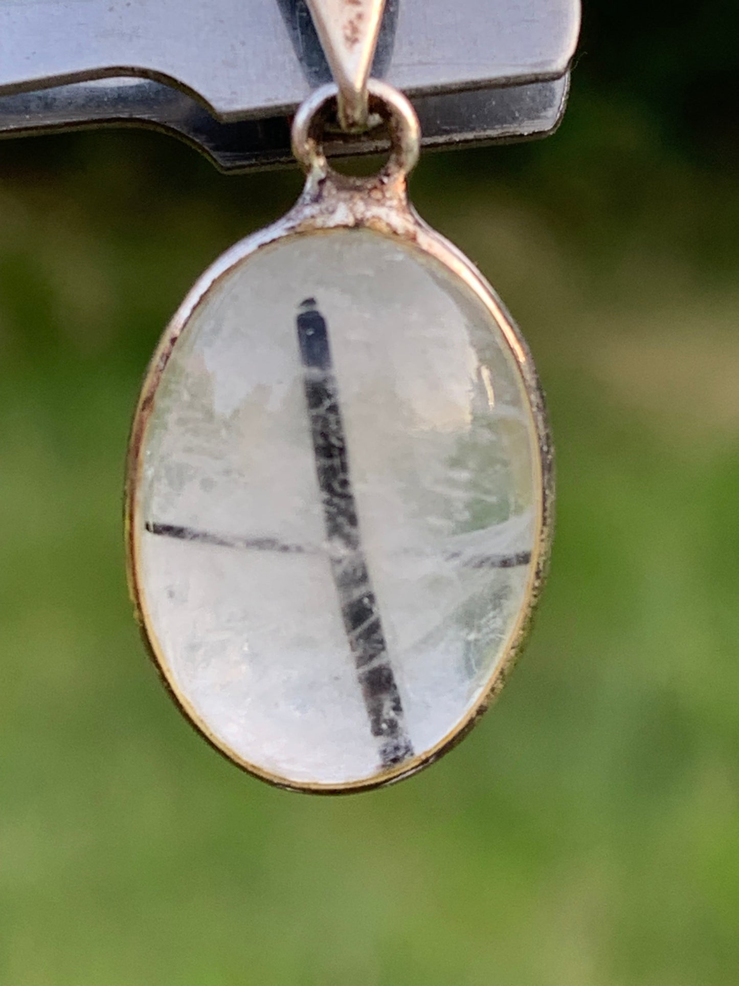Rock crystal/quartz with black tourmaline inclusions! Silver pendant, 28mm high x13 x7. Sold with an adjustable black cord!