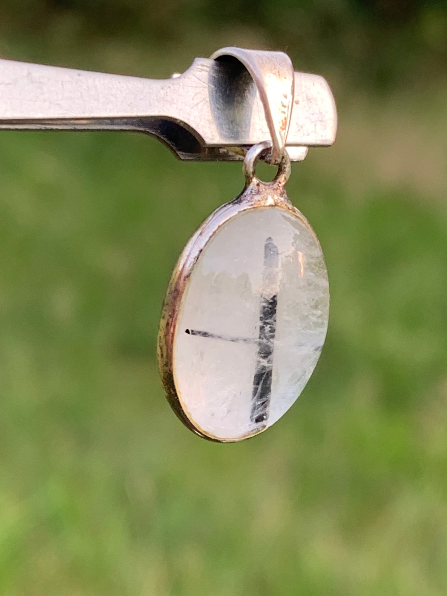 Rock crystal/quartz with black tourmaline inclusions! Silver pendant, 28mm high x13 x7. Sold with an adjustable black cord!