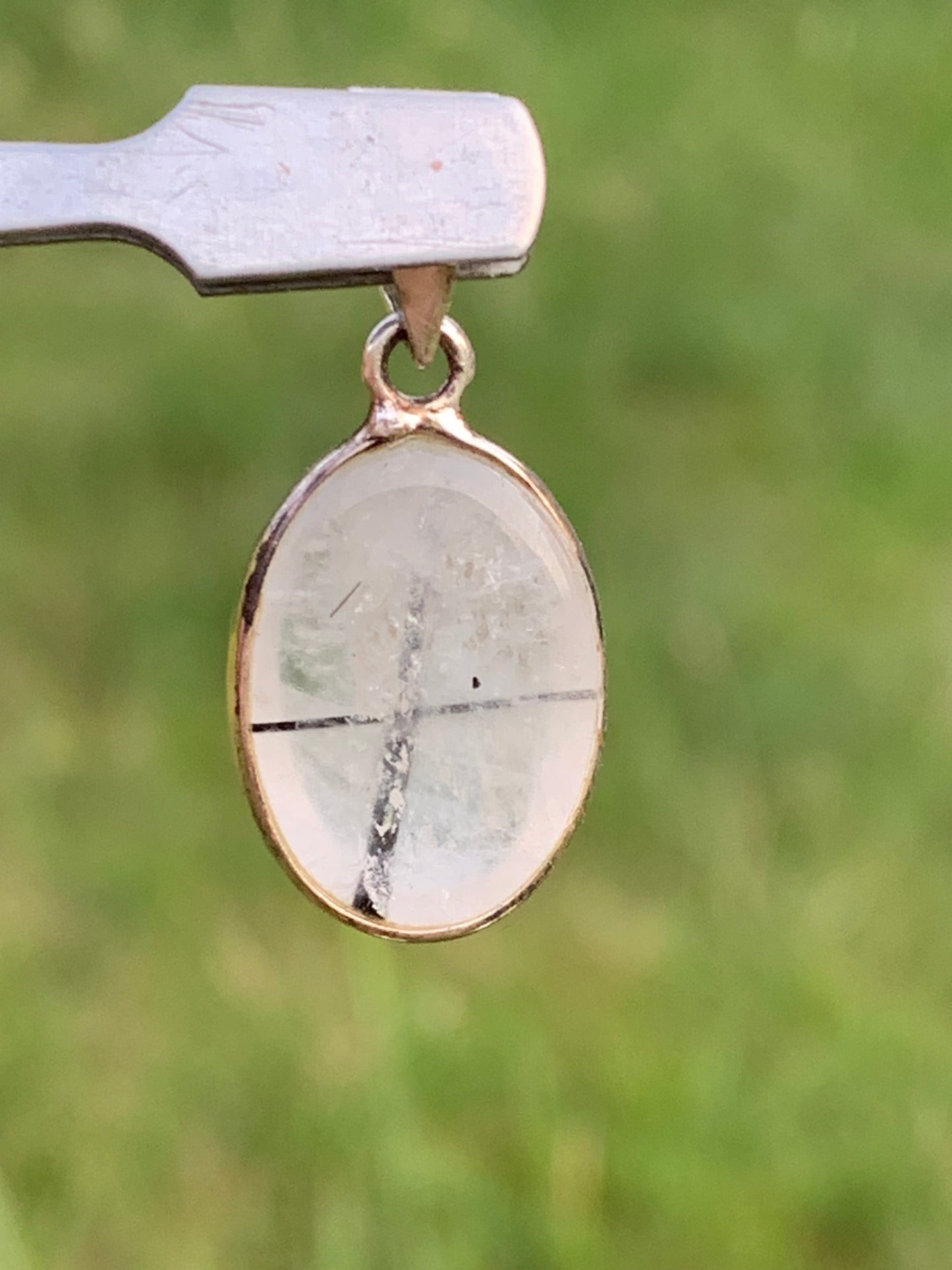Rock crystal/quartz with black tourmaline inclusions! Silver pendant, 28mm high x13 x7. Sold with an adjustable black cord!