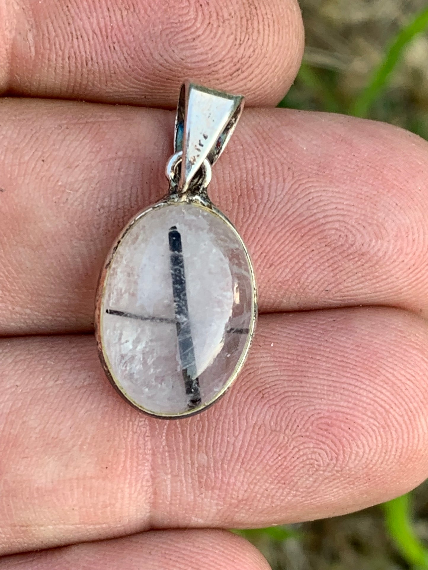 Rock crystal/quartz with black tourmaline inclusions! Silver pendant, 28mm high x13 x7. Sold with an adjustable black cord!