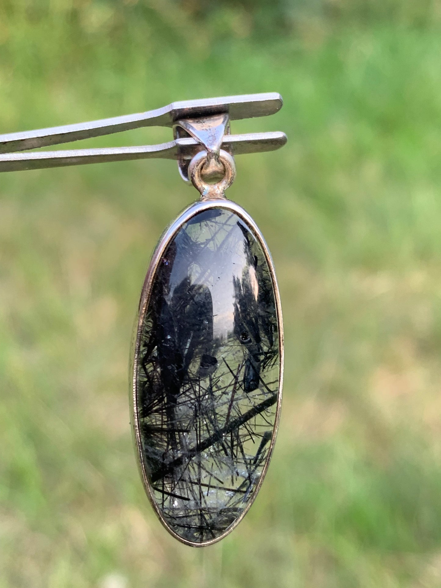 Rock crystal/quartz with black tourmaline inclusions! Silver pendant, 45mm high x15 x8. Sold with adjustable black cord!