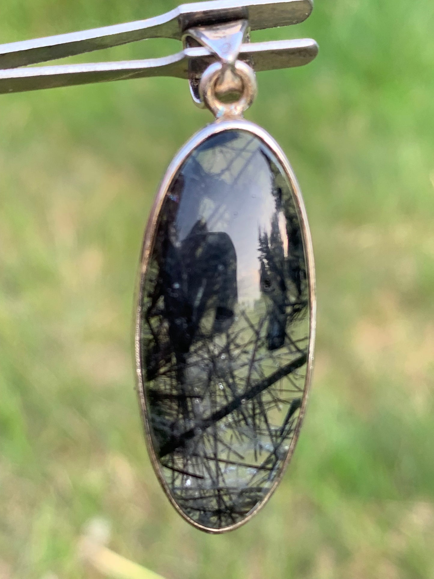 Rock crystal/quartz with black tourmaline inclusions! Silver pendant, 45mm high x15 x8. Sold with adjustable black cord!