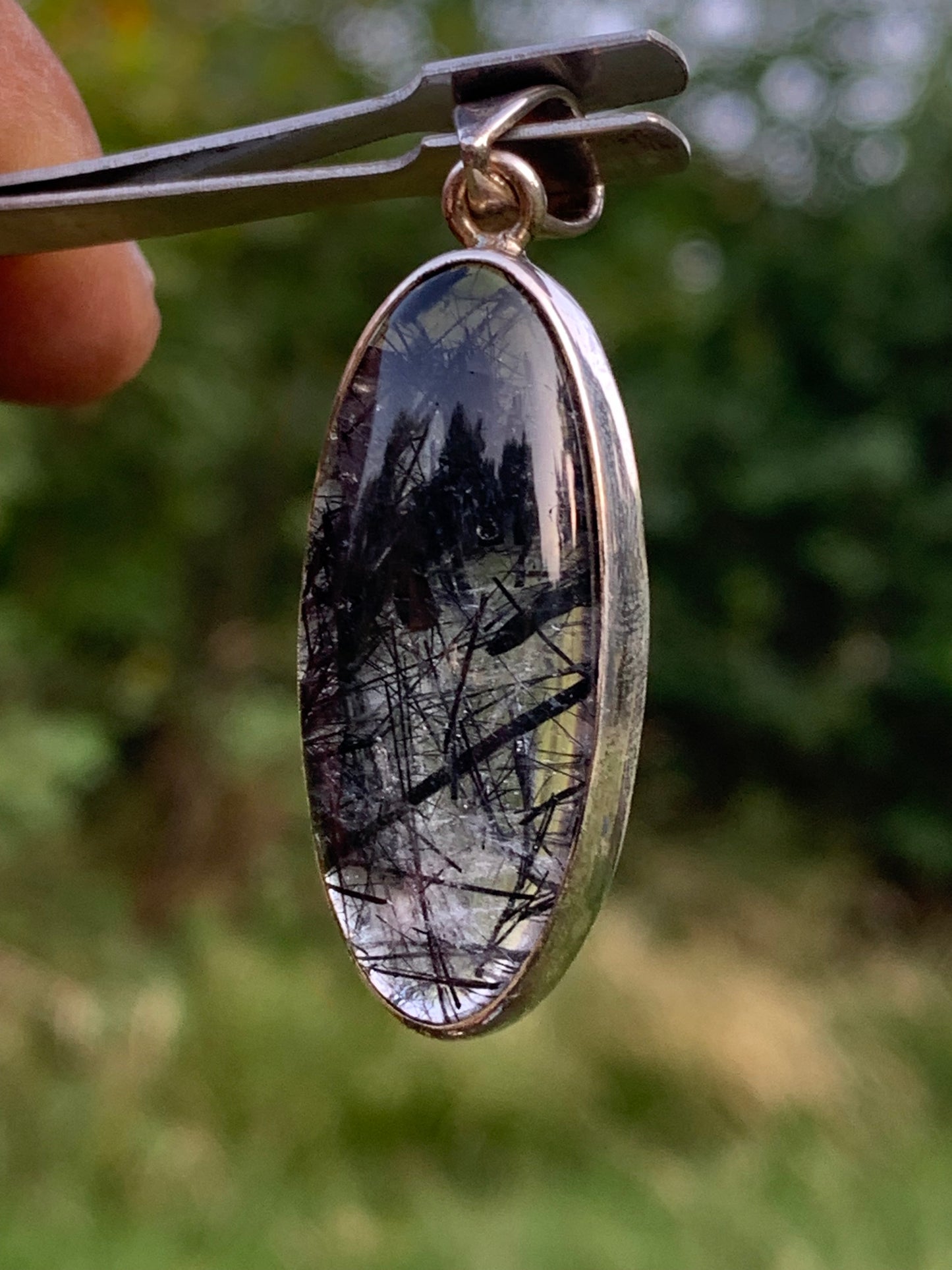 Rock crystal/quartz with black tourmaline inclusions! Silver pendant, 45mm high x15 x8. Sold with adjustable black cord!