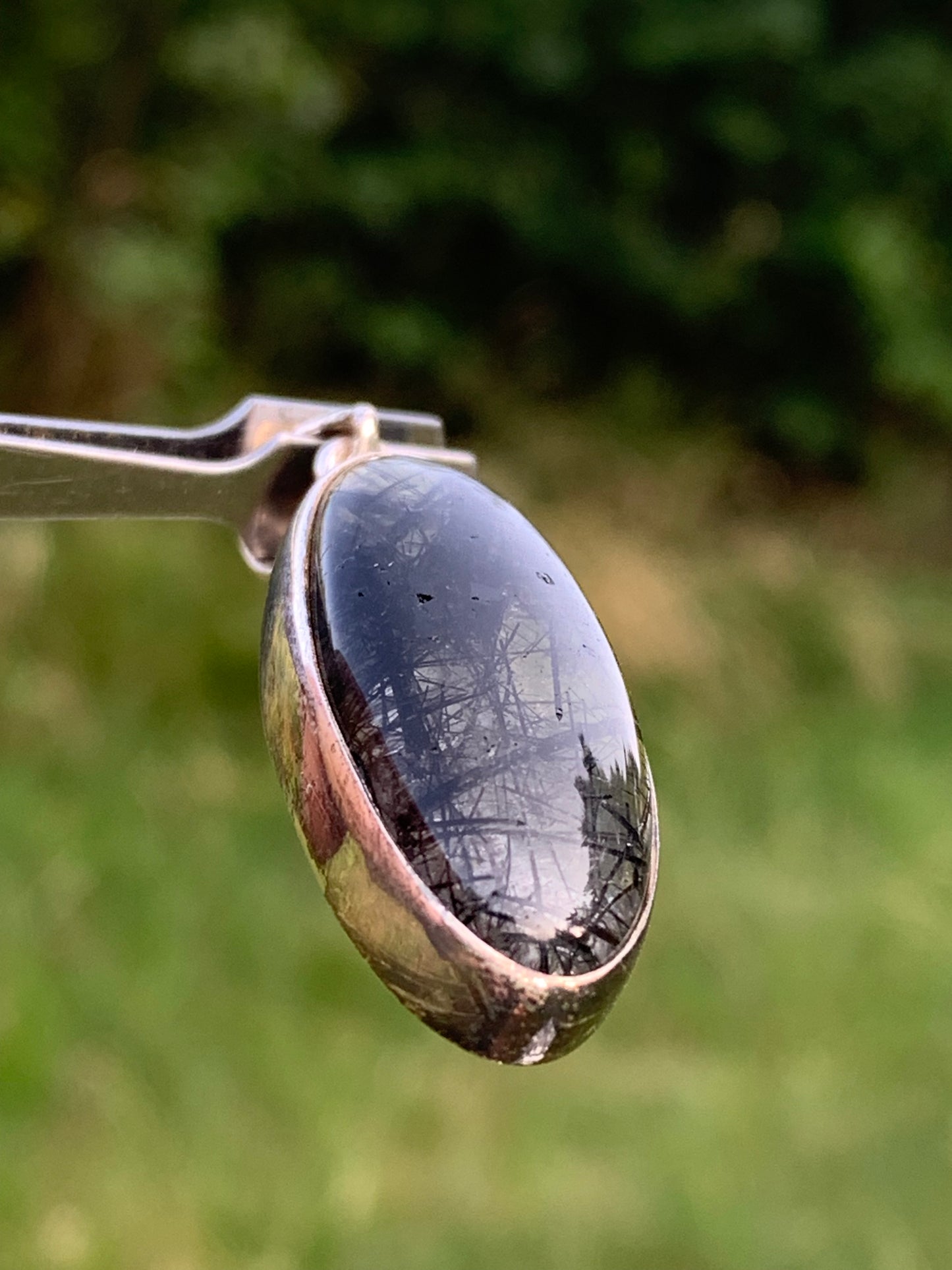 Rock crystal/quartz with black tourmaline inclusions! Silver pendant, 45mm high x15 x8. Sold with adjustable black cord!