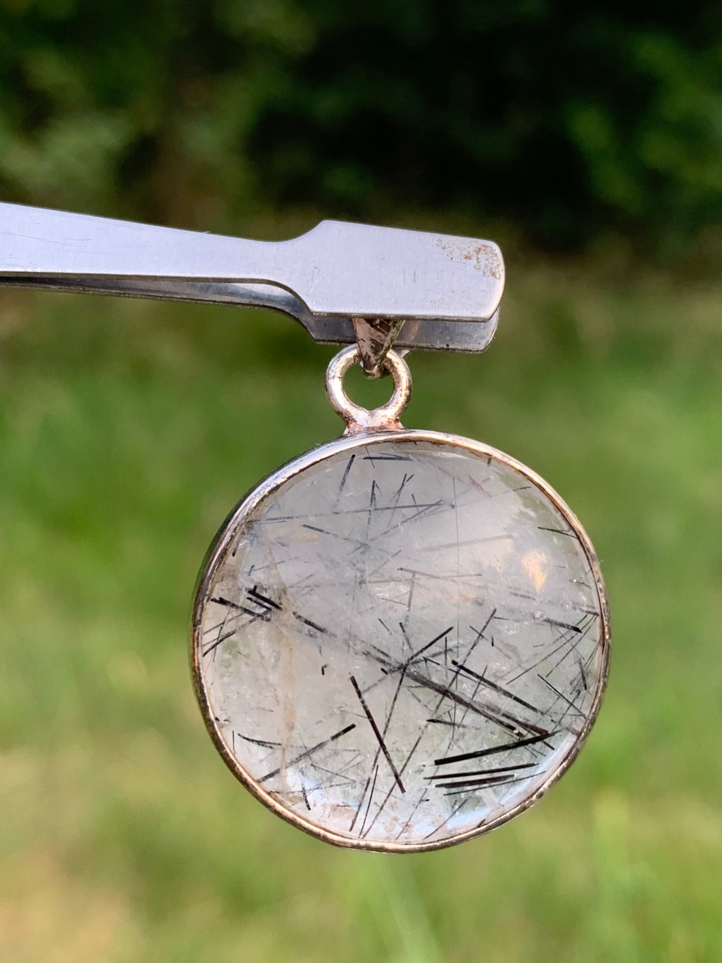 Rock crystal/quartz with black tourmaline inclusions! Silver pendant, 35mm high x26 x8. Sold with an adjustable black cord!