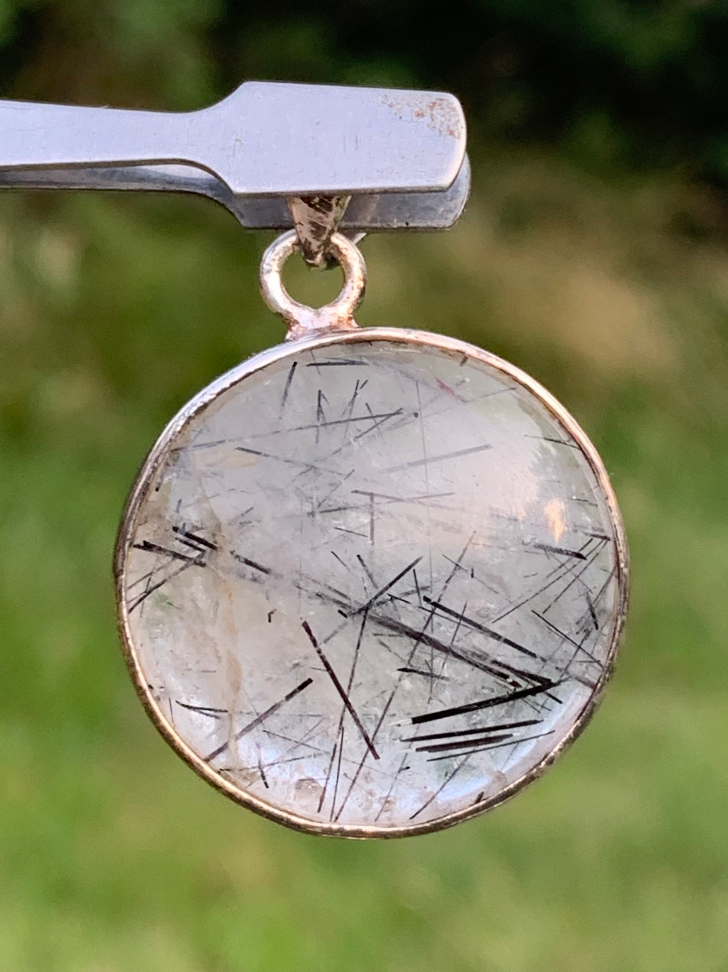 Rock crystal/quartz with black tourmaline inclusions! Silver pendant, 35mm high x26 x8. Sold with an adjustable black cord!