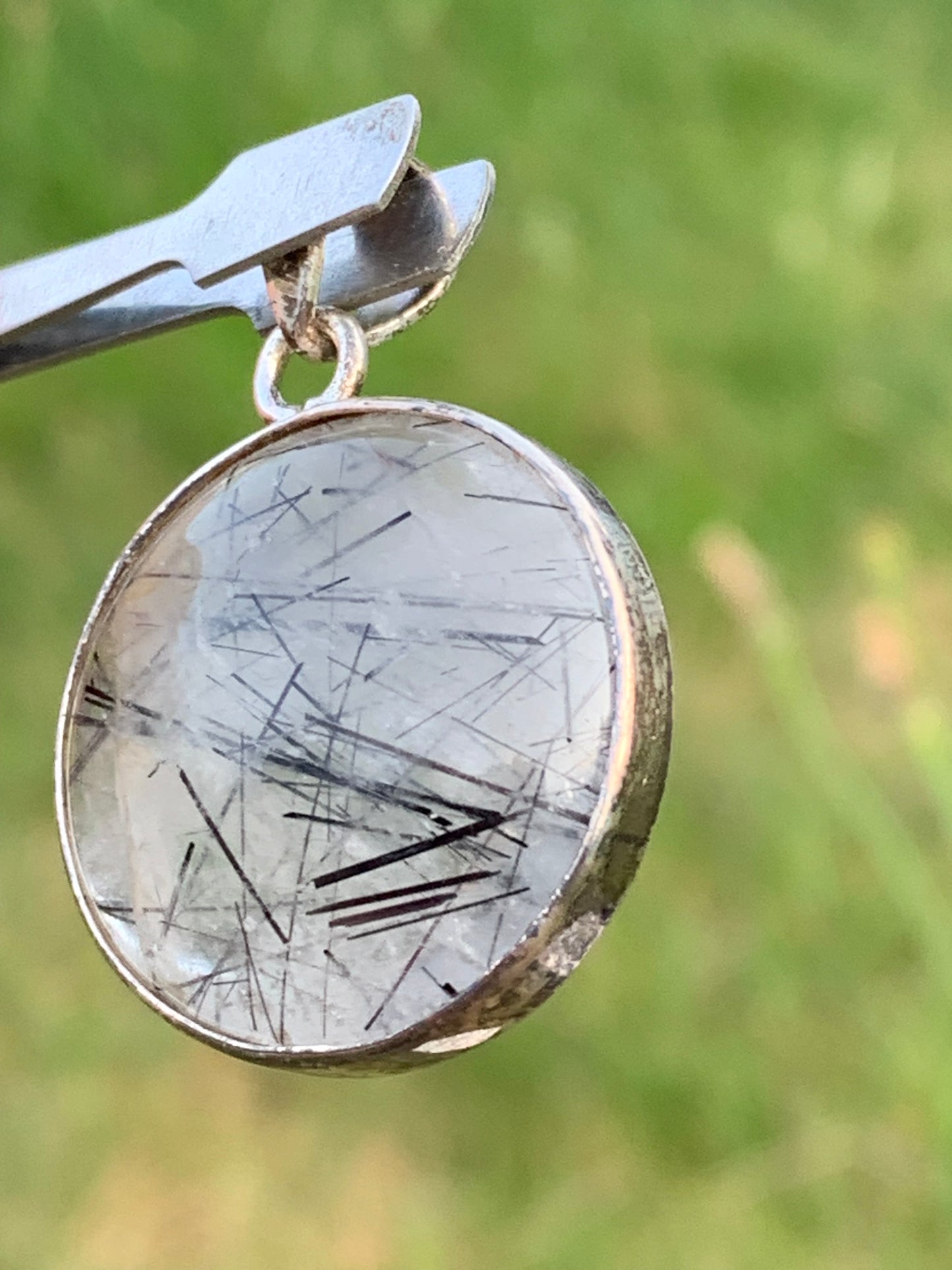 Rock crystal/quartz with black tourmaline inclusions! Silver pendant, 35mm high x26 x8. Sold with an adjustable black cord!