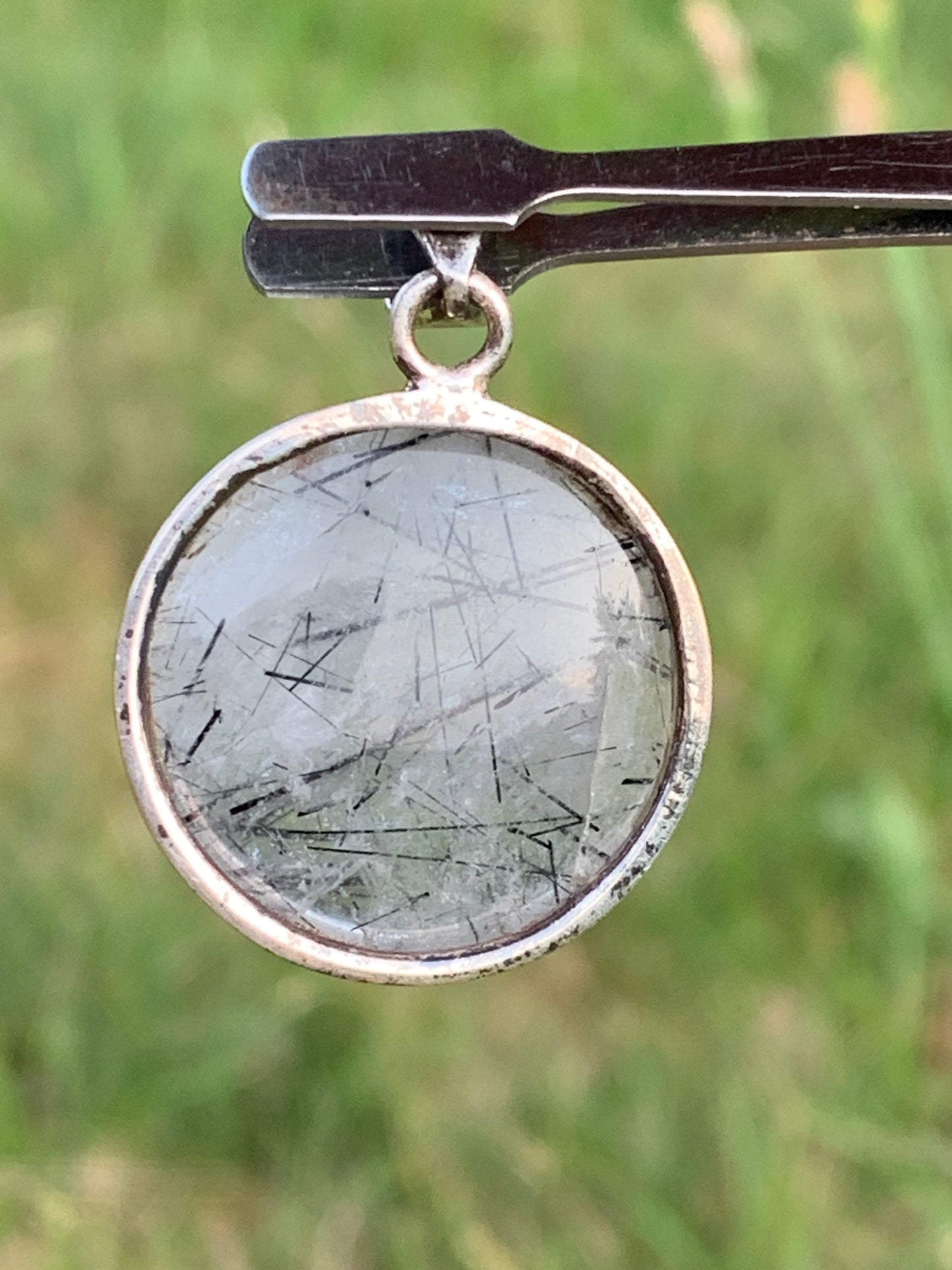 Rock crystal/quartz with black tourmaline inclusions! Silver pendant, 35mm high x26 x8. Sold with an adjustable black cord!