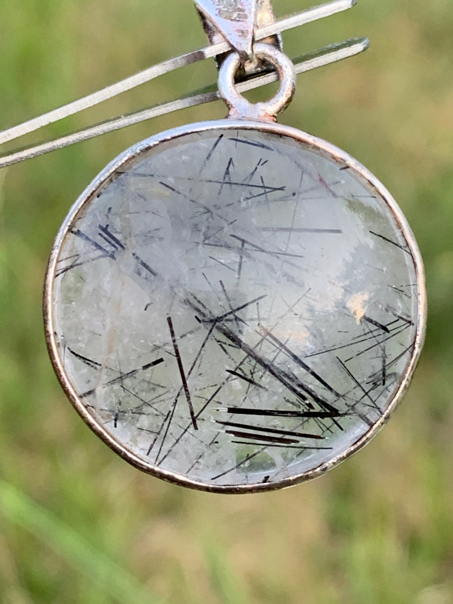 Rock crystal/quartz with black tourmaline inclusions! Silver pendant, 35mm high x26 x8. Sold with an adjustable black cord!