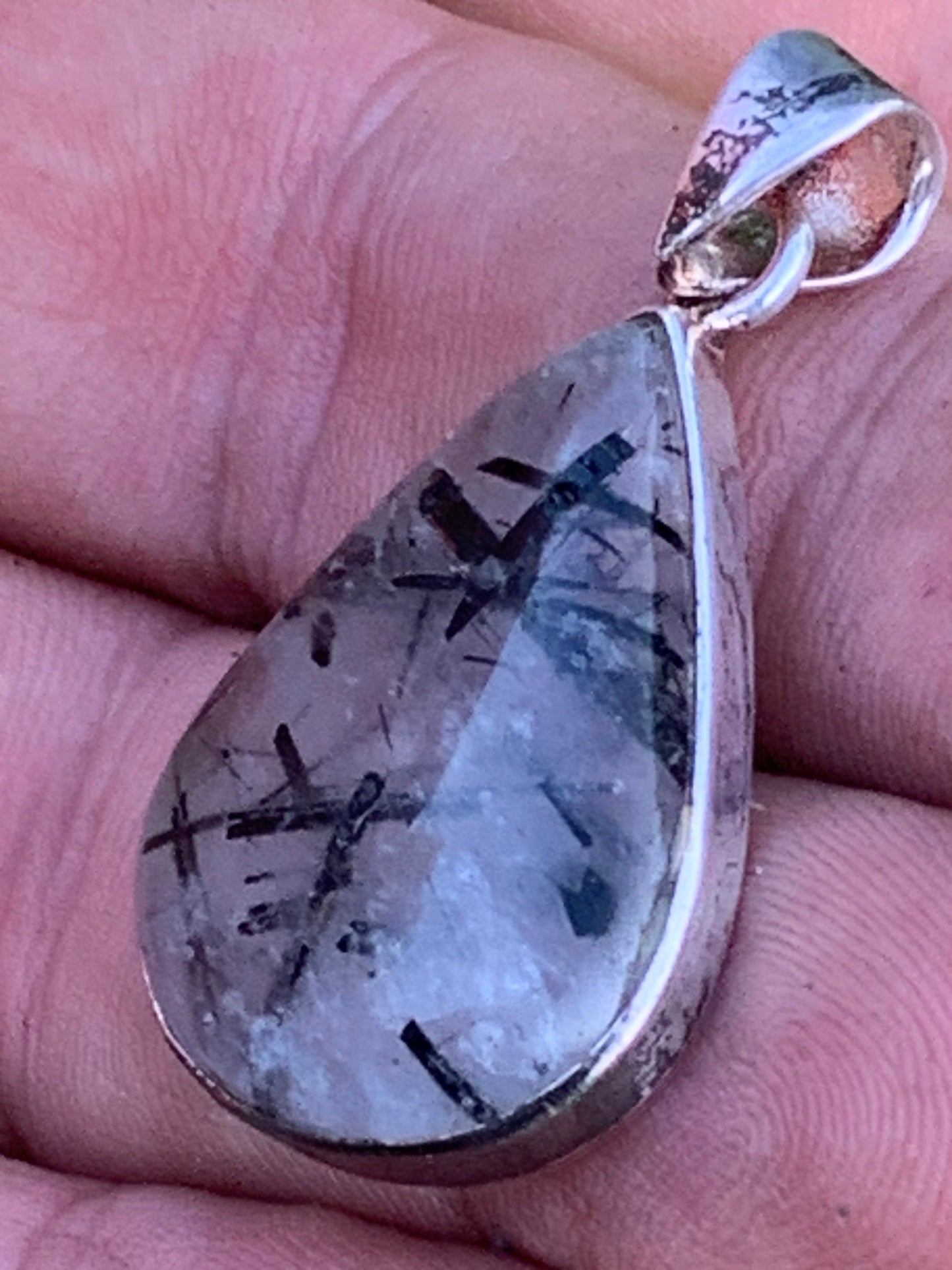 Rock crystal/quartz with black tourmaline inclusions! Silver pendant, 38mm high x21 x7. Sold with adjustable black cord!